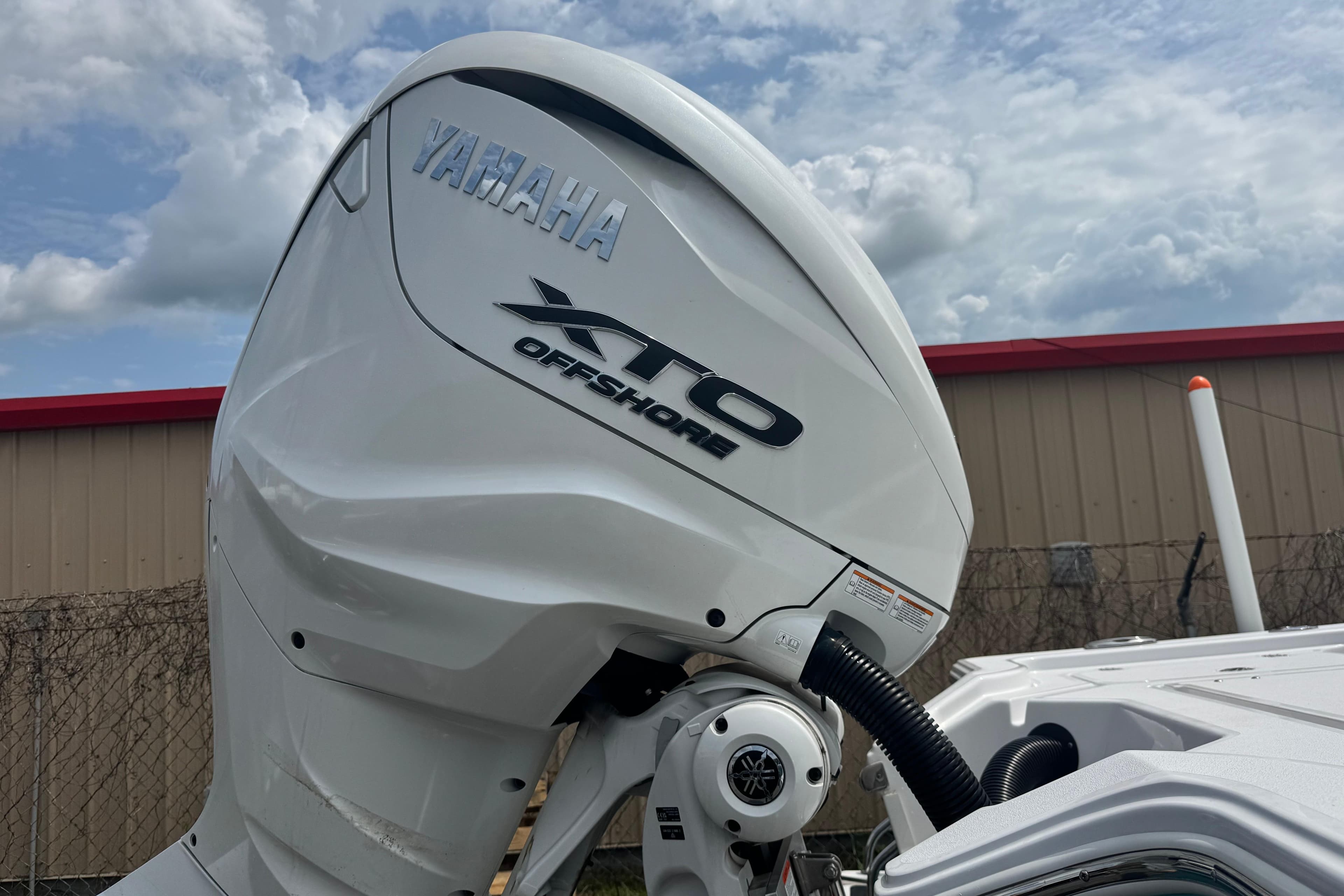 Yamaha XTO Offshore engine on 2024 Sportsman Masters 267 Bay Boat under cloudy sky.