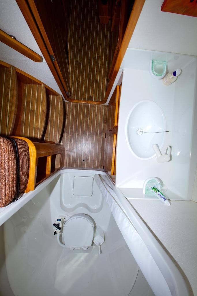 Bathroom interior of 2000 Privilege 37 yacht with wooden flooring and compact amenities.