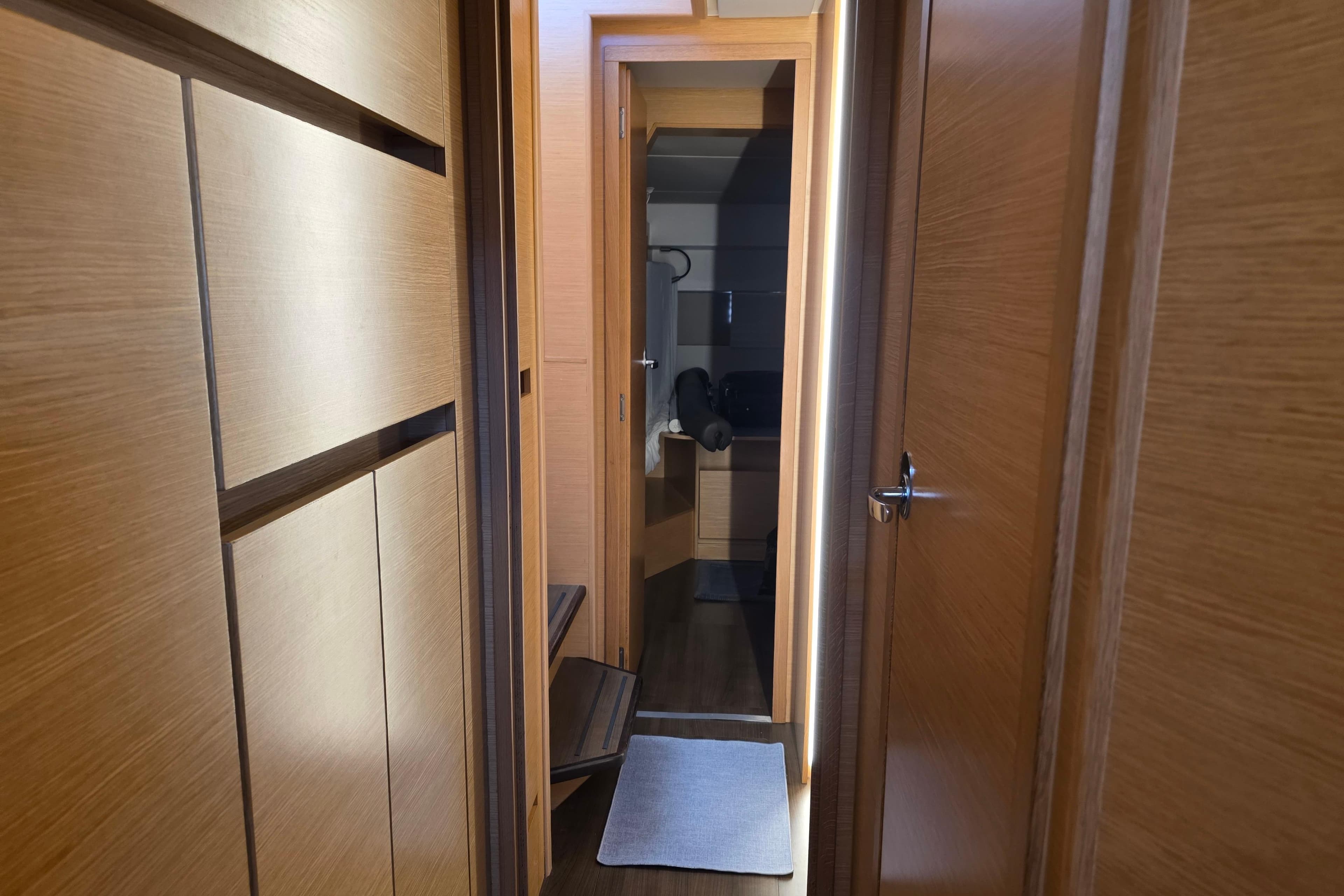 Interior hallway of 2019 Nautitech 46 Open yacht with wooden finish.