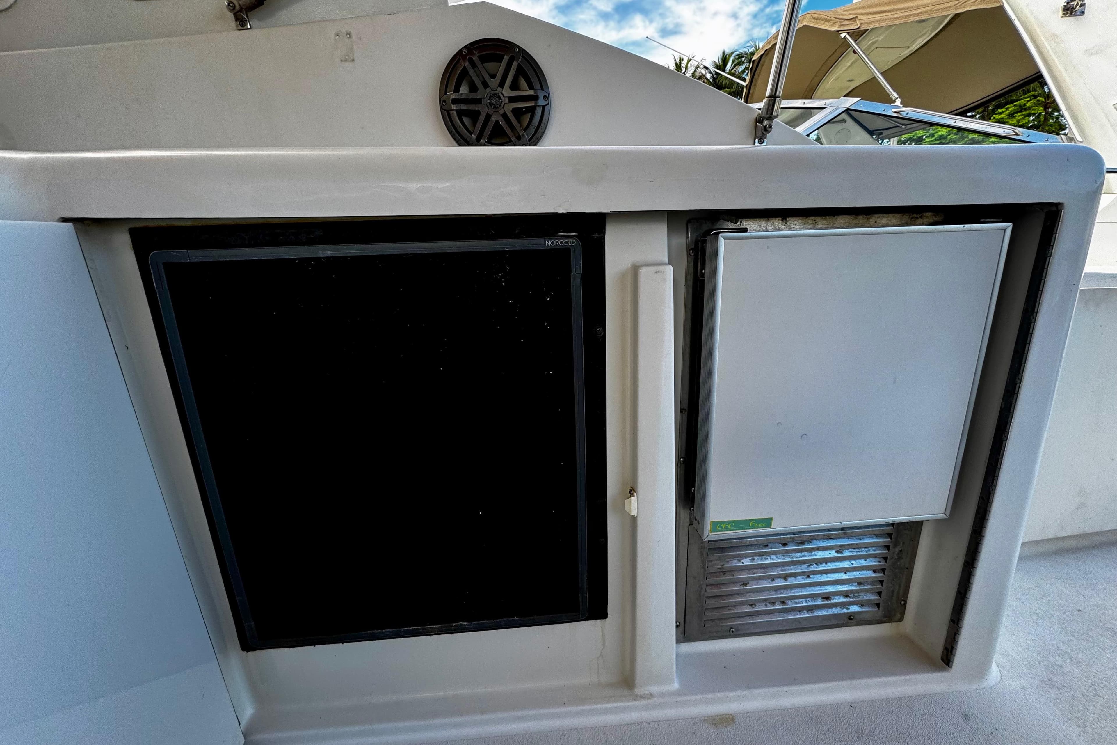 Trojan 440 Express 2000 boat interior with built-in refrigerator and storage compartment.