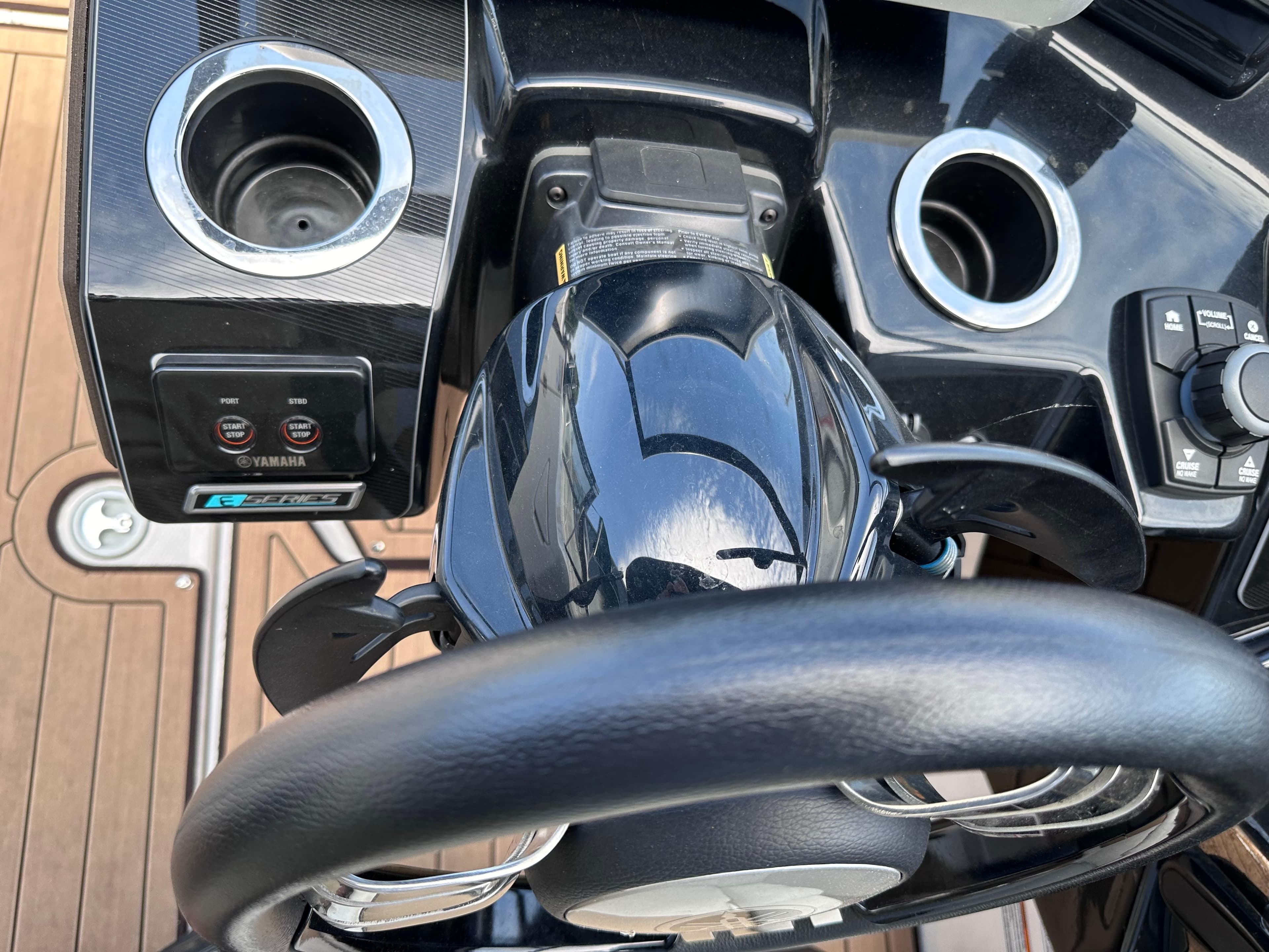 Close-up of the 2021 Yamaha Boats 252 SD steering wheel and control panel.