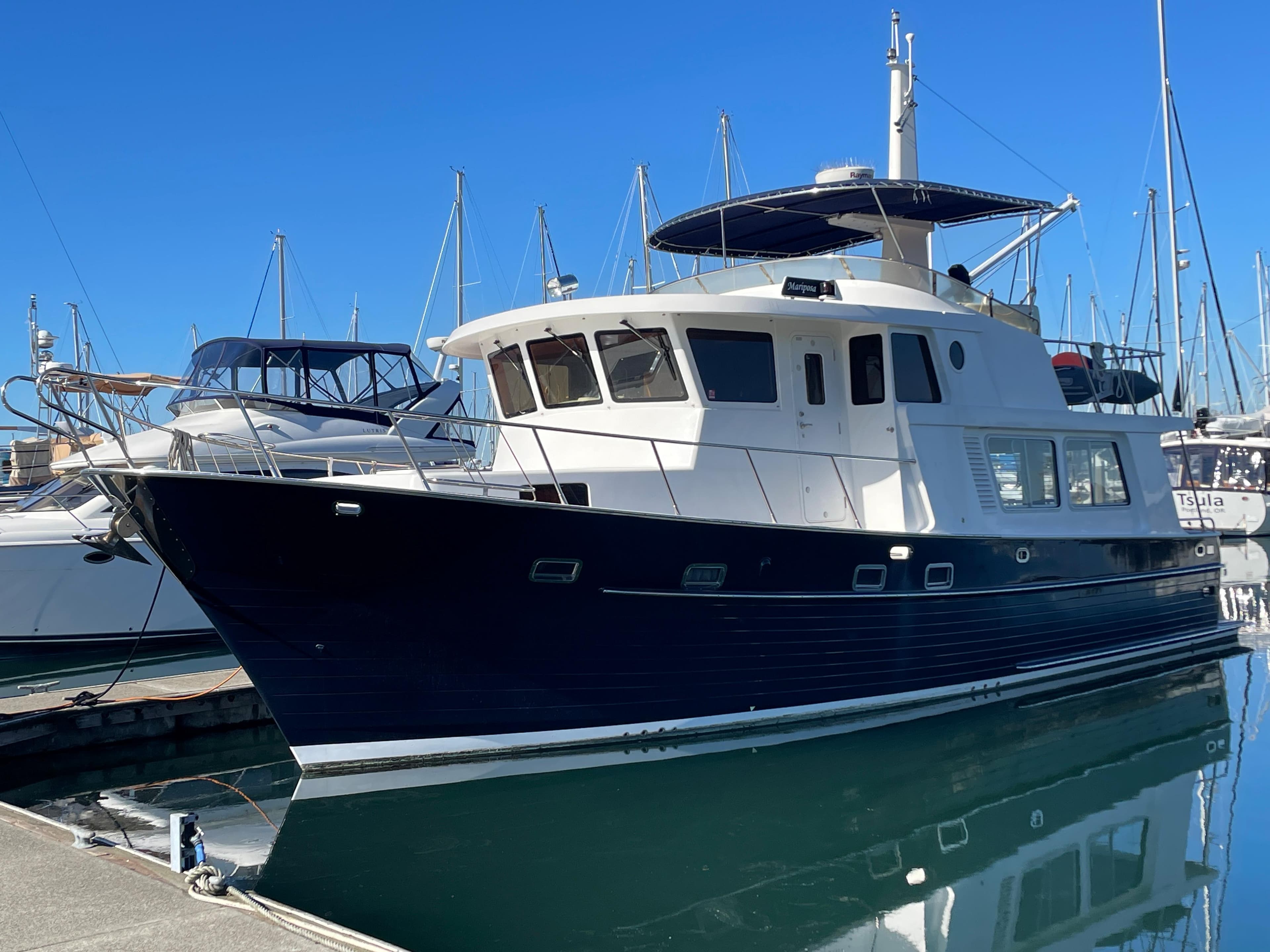 Integrity 45 yacht, 2012 model, docked at marina with clear blue sky.