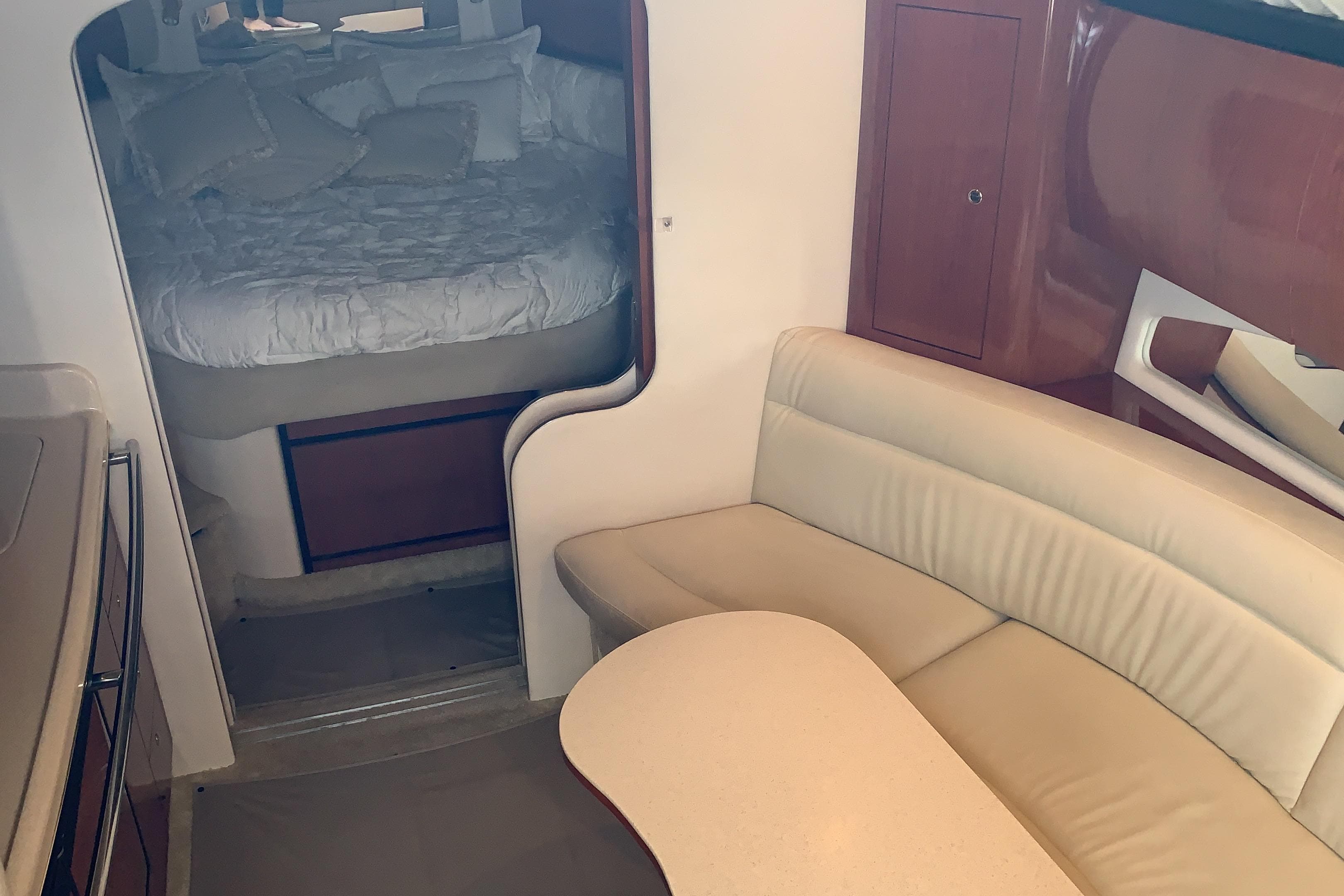 Interior of 2002 Sea Ray 360 Sundancer with cozy seating and sleeping area.