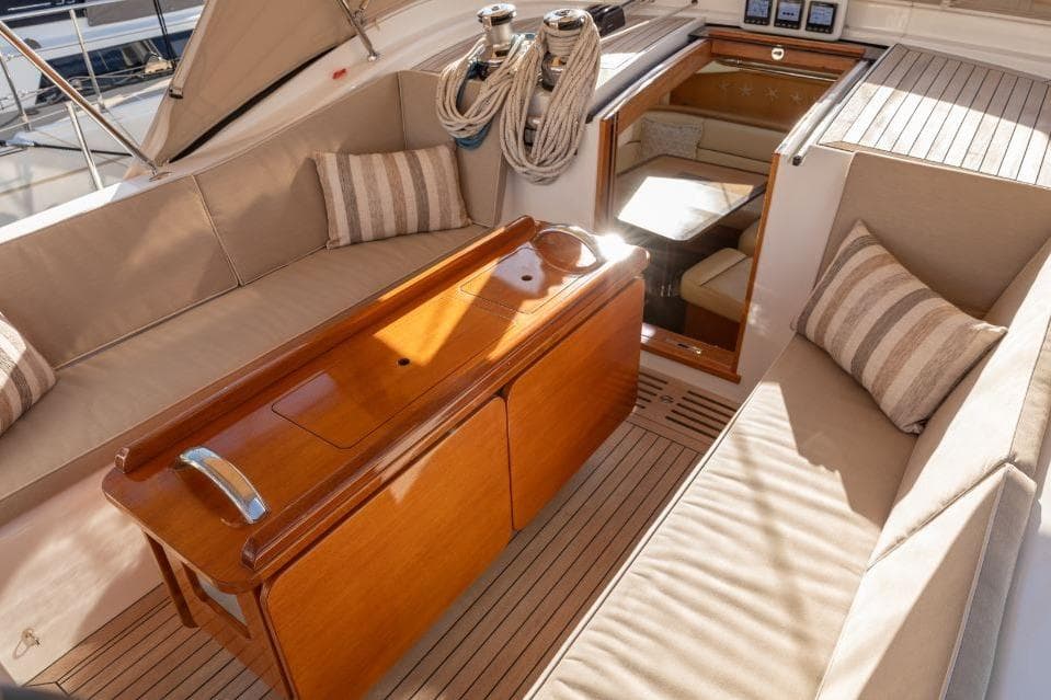Luxurious 2015 Discovery 58 yacht interior with elegant seating and wooden table.