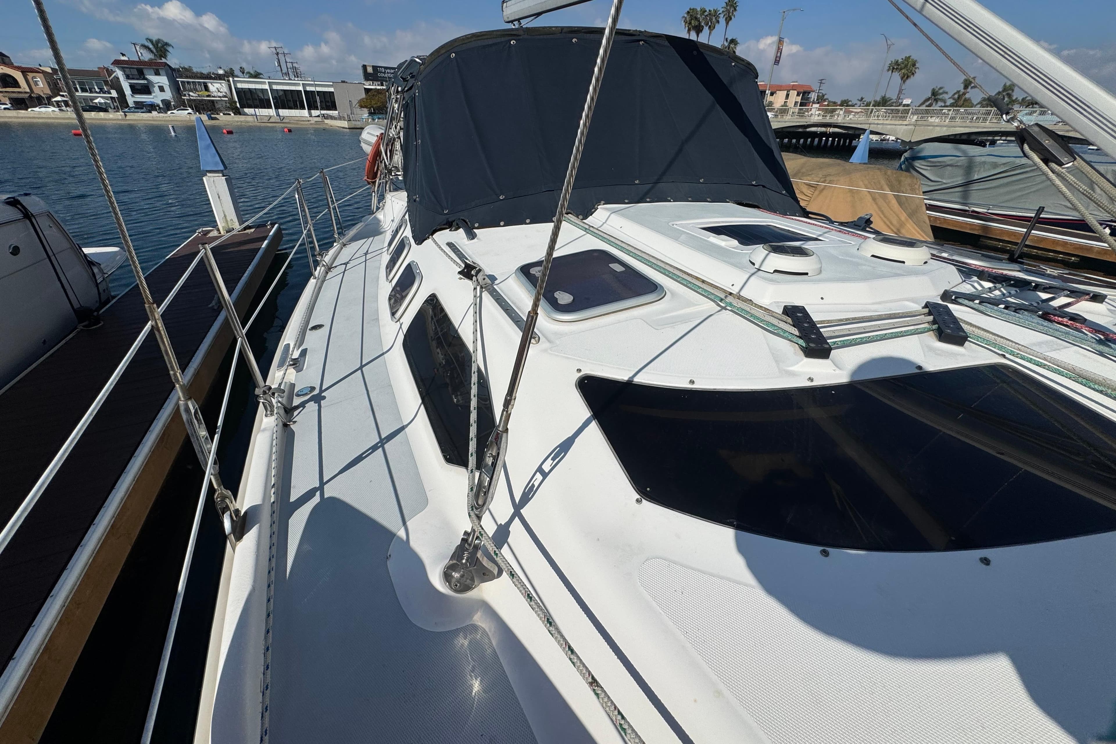 Sailboat docked at marina, 2000 Hunter 460 model, sunny day.