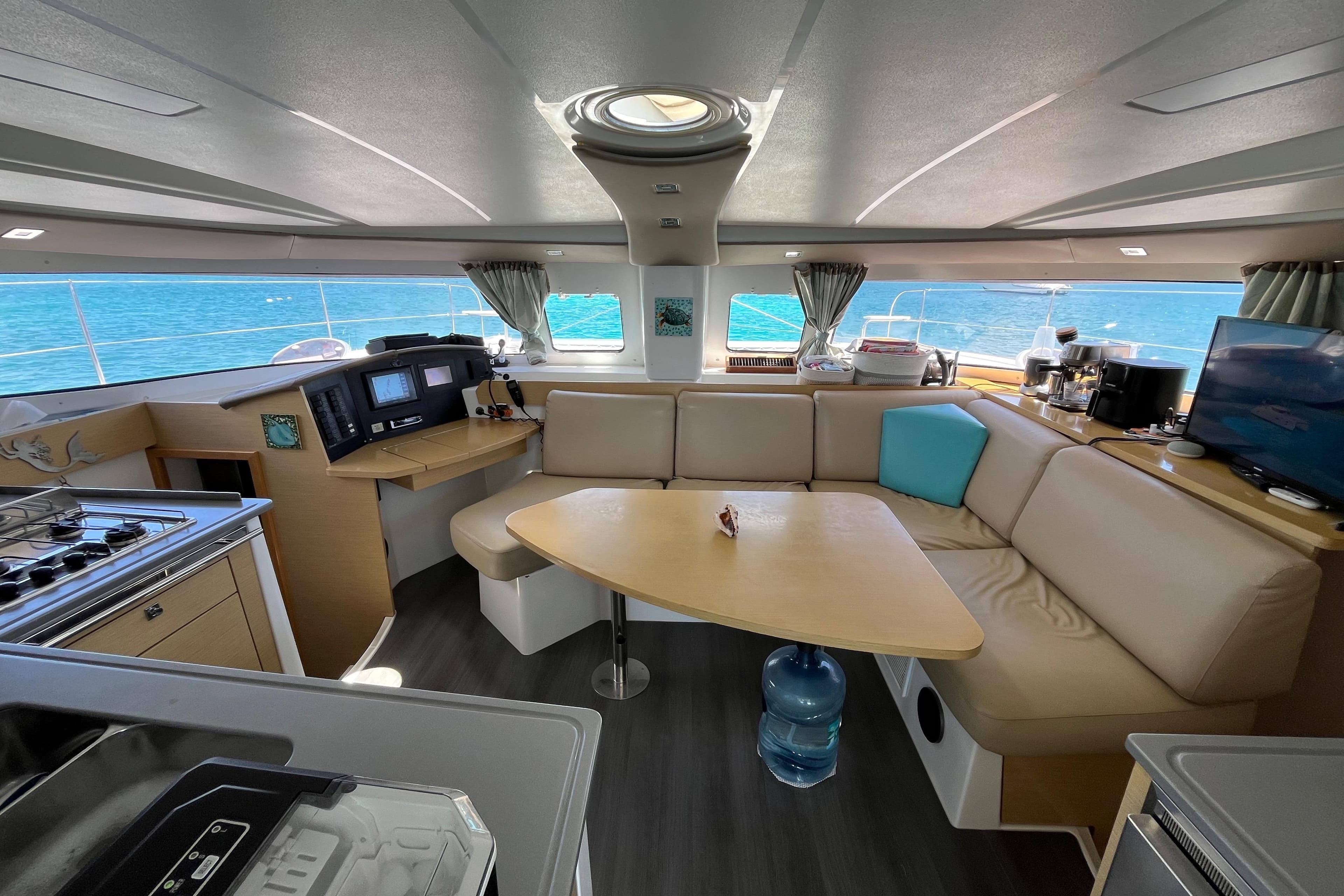 Interior of 2015 Fountaine Pajot Lipari 41 catamaran with modern seating and kitchen area.