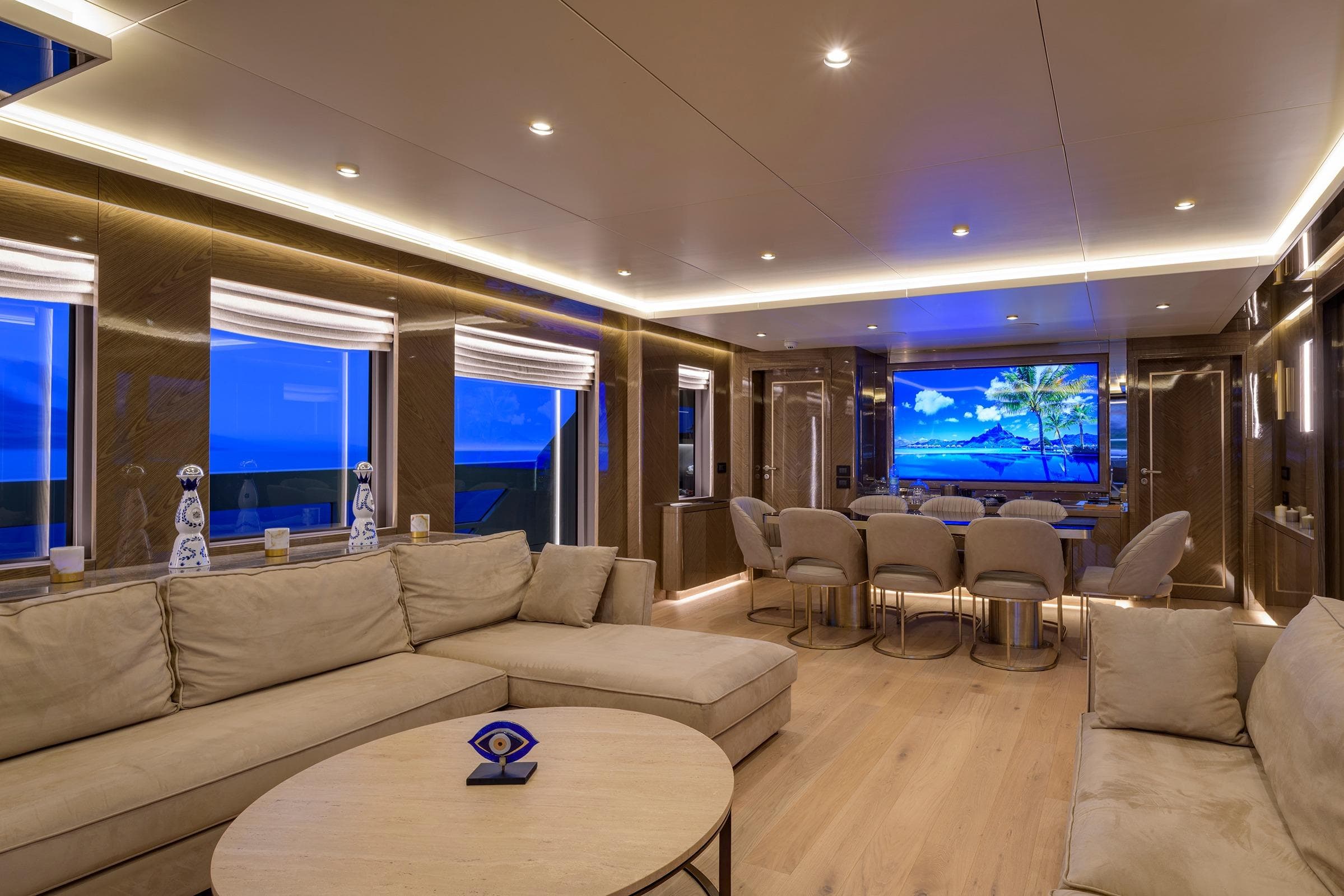 Luxurious yacht interior with modern decor, featuring a large screen and elegant seating, Blaundus V30 Explorer.
