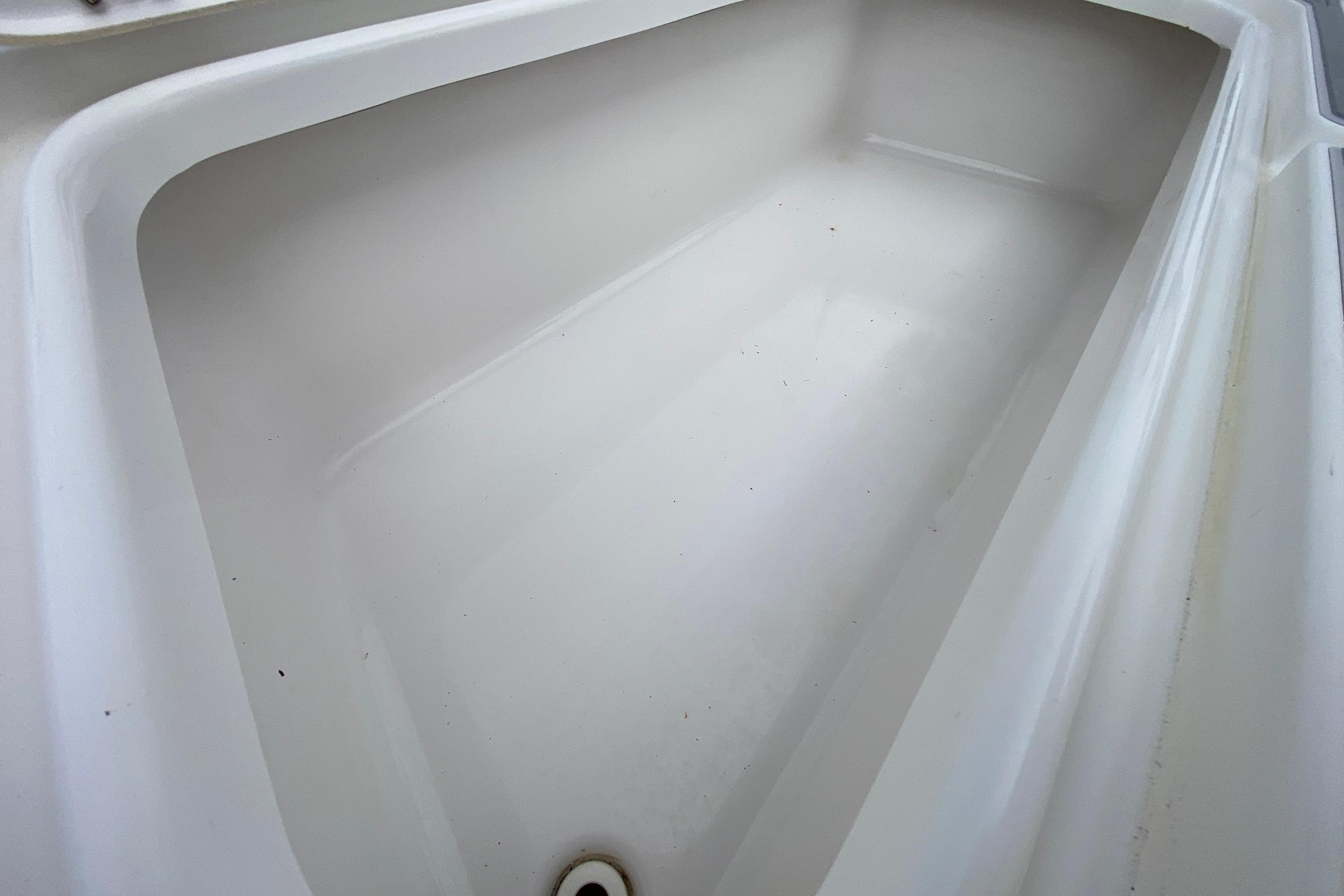 Storage compartment of 2004 Palmetto 22 Excursion boat, featuring clean white interior.