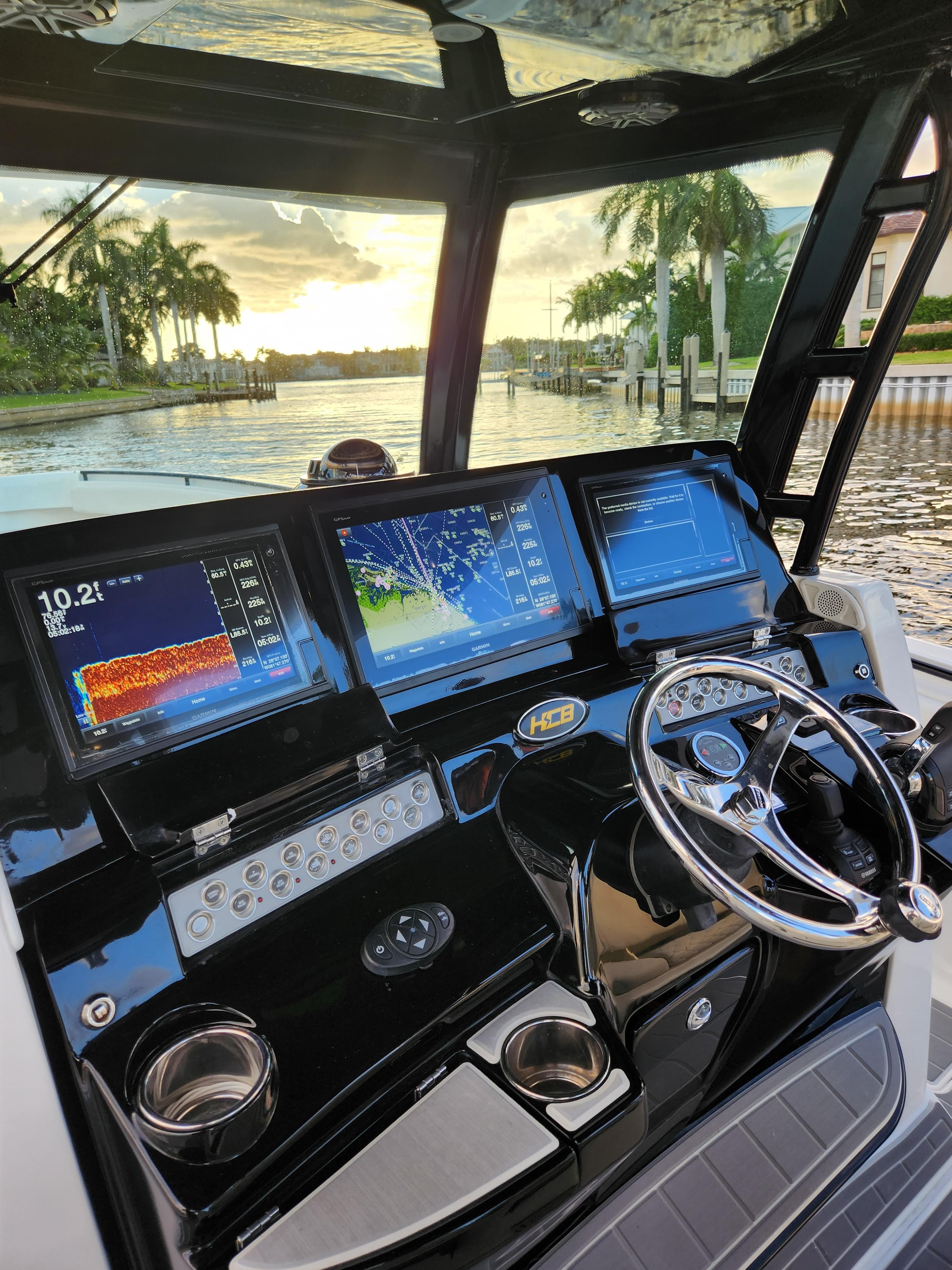 2019 HCB 39 Speciale boat dashboard with advanced navigation screens at sunset.