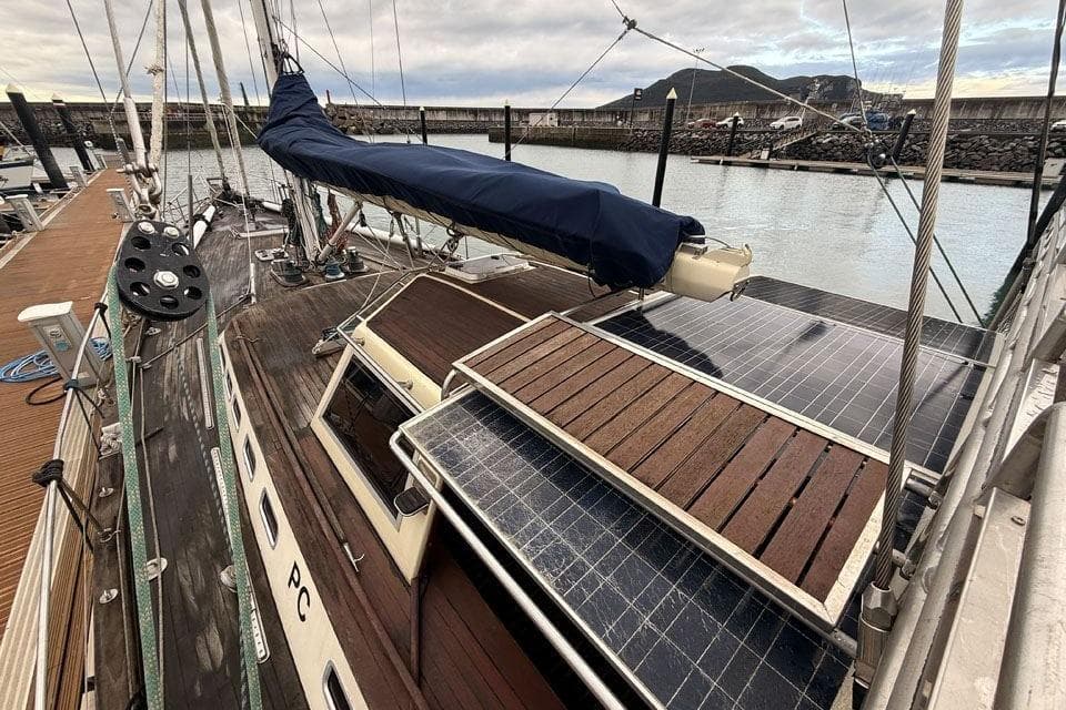 23m Custom Sloop, 2012 model, docked with solar panels and covered sail.