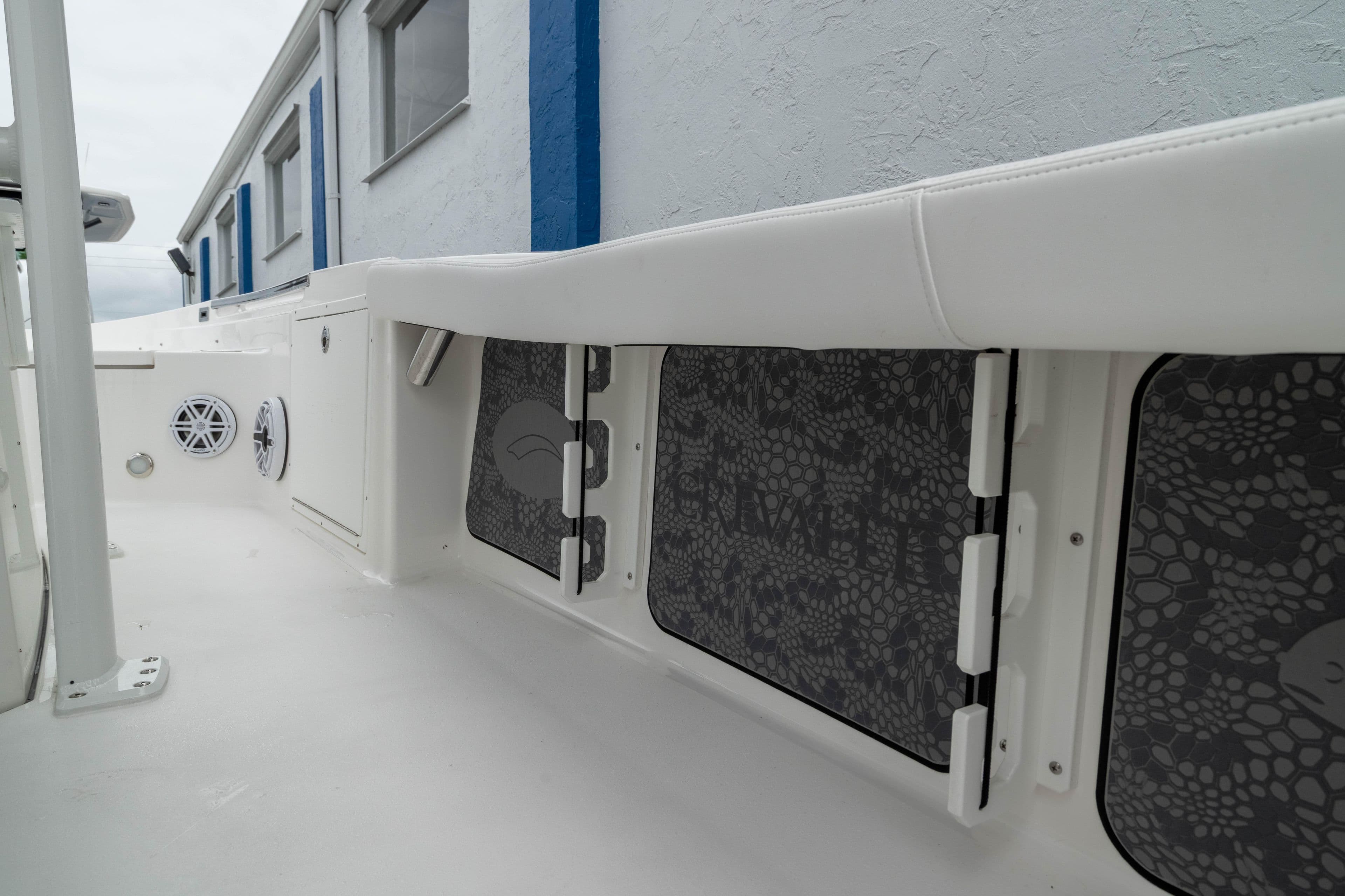 2026 Crevalle 24 HCO boat interior with storage compartments and speakers.