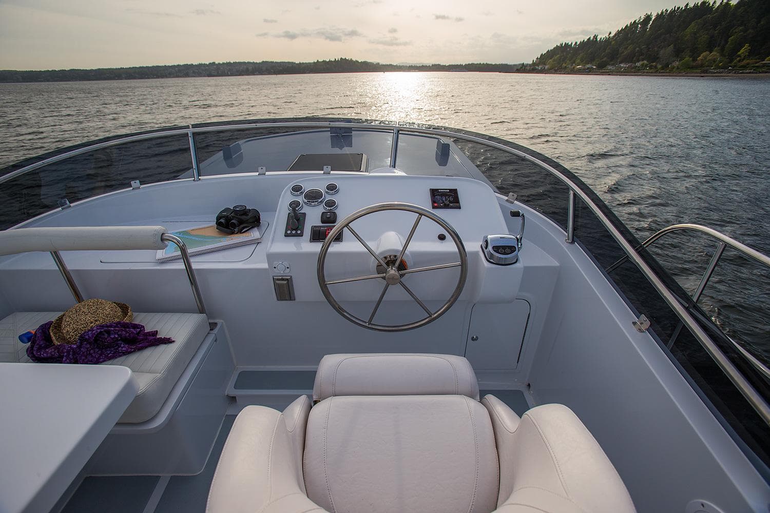 Helmsman Trawlers 38E Pilothouse 2026, serene cockpit view at sunset on open water.