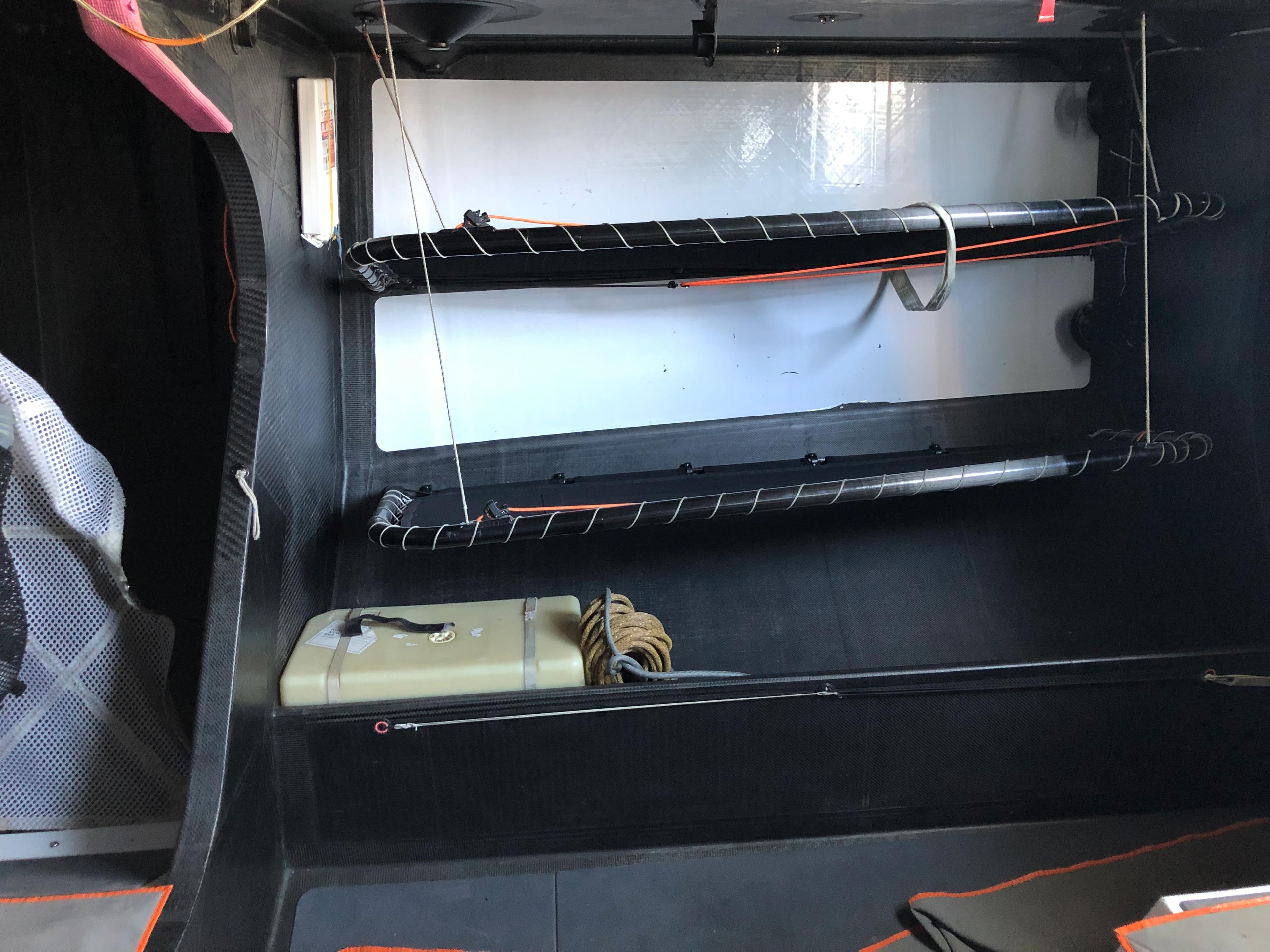 Interior of a 2013 Farr VO 65 yacht, featuring storage compartments and sailing equipment.
