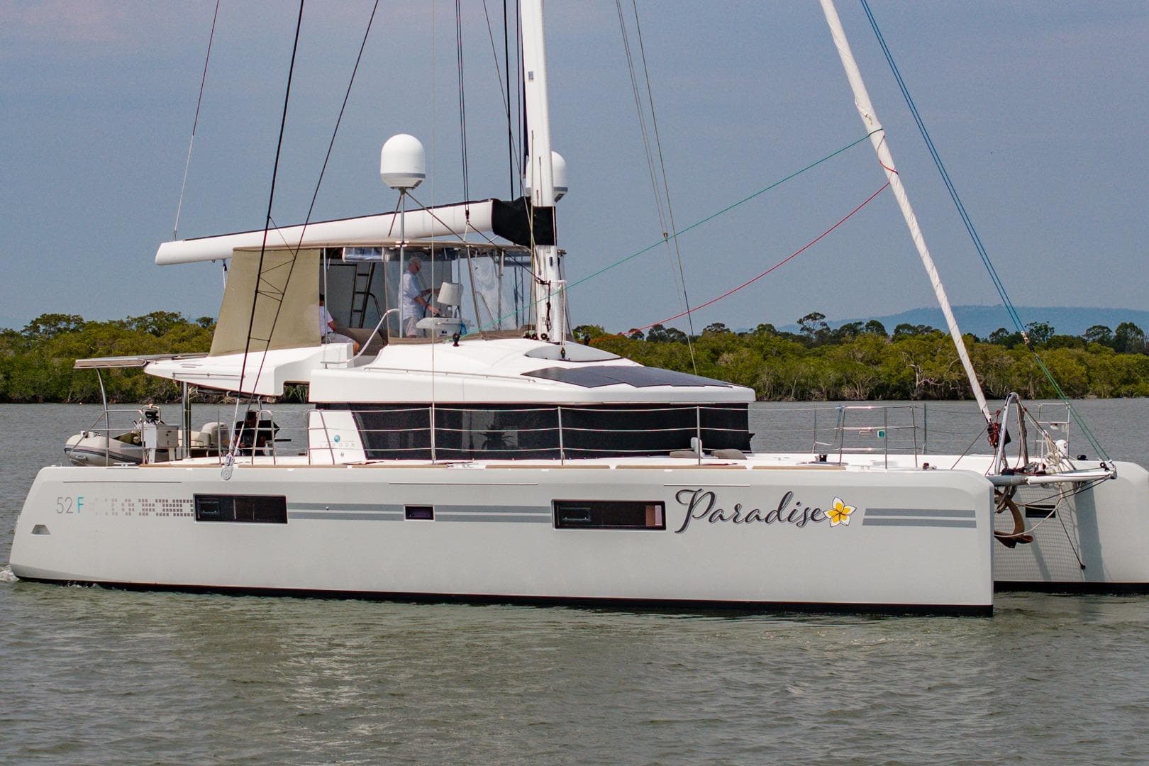2017 Lagoon 52 F catamaran named "Paradise" sailing on calm waters.