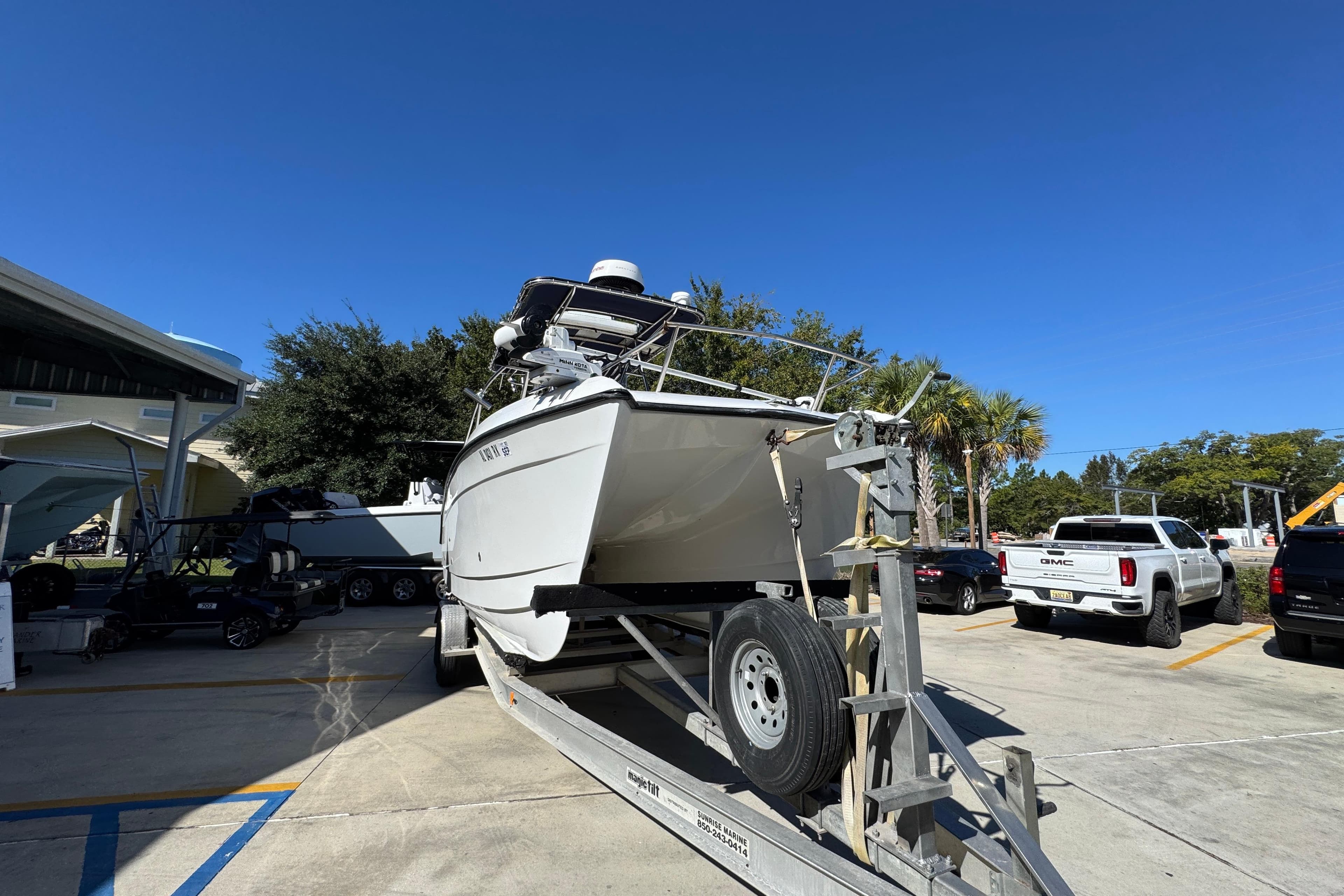 2005 Glacier Bay 260 Canyon Runner boat on trailer in parking lot.