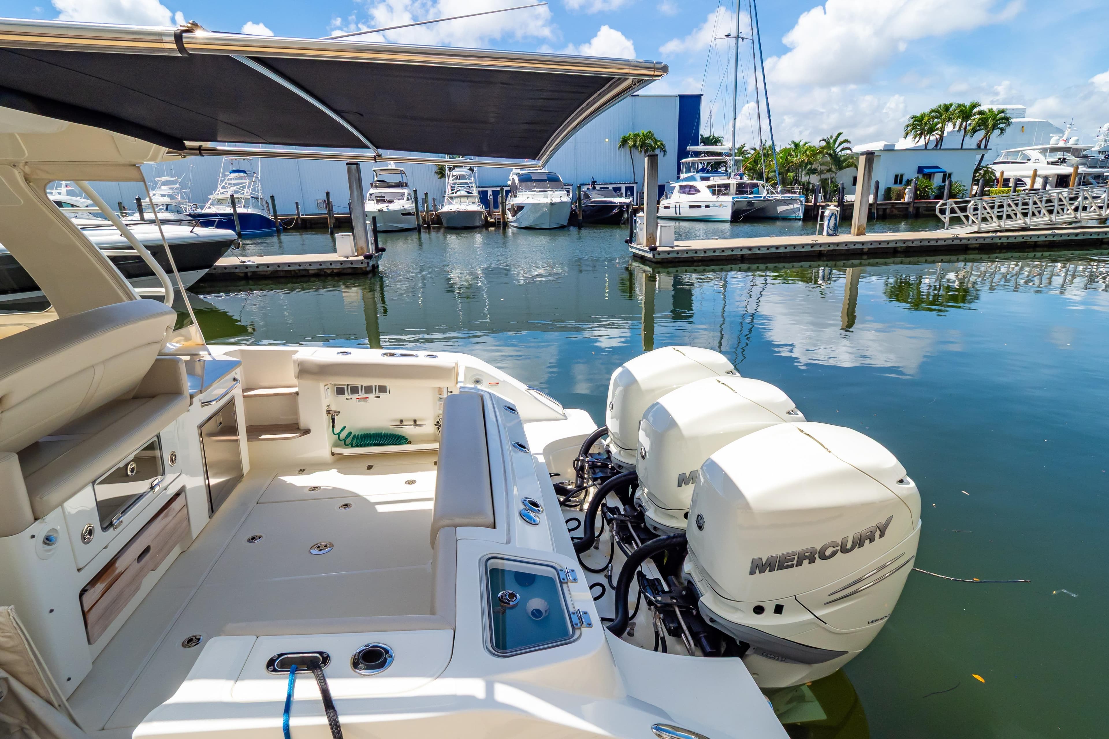 2019 Boston Whaler 350 Realm with Mercury engines docked at marina.
