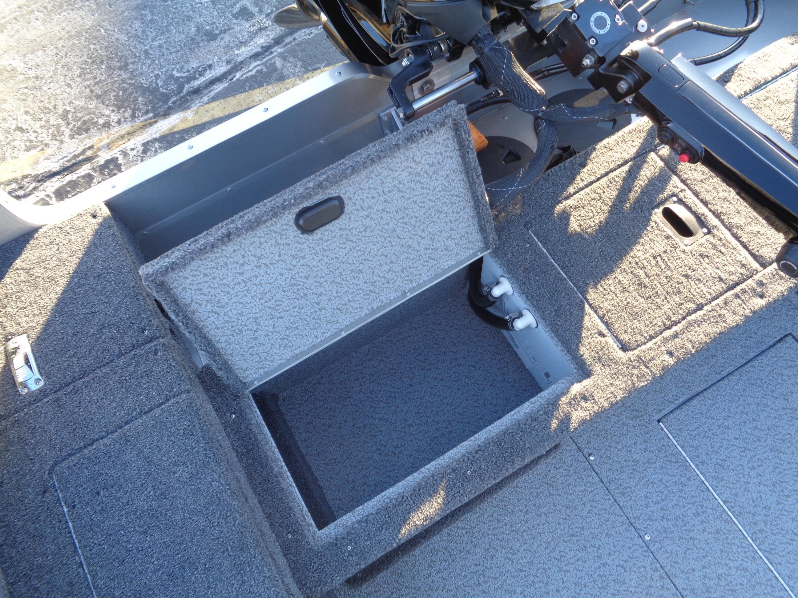 2025 Lund 1875 Pro Guide boat interior with open storage compartment.