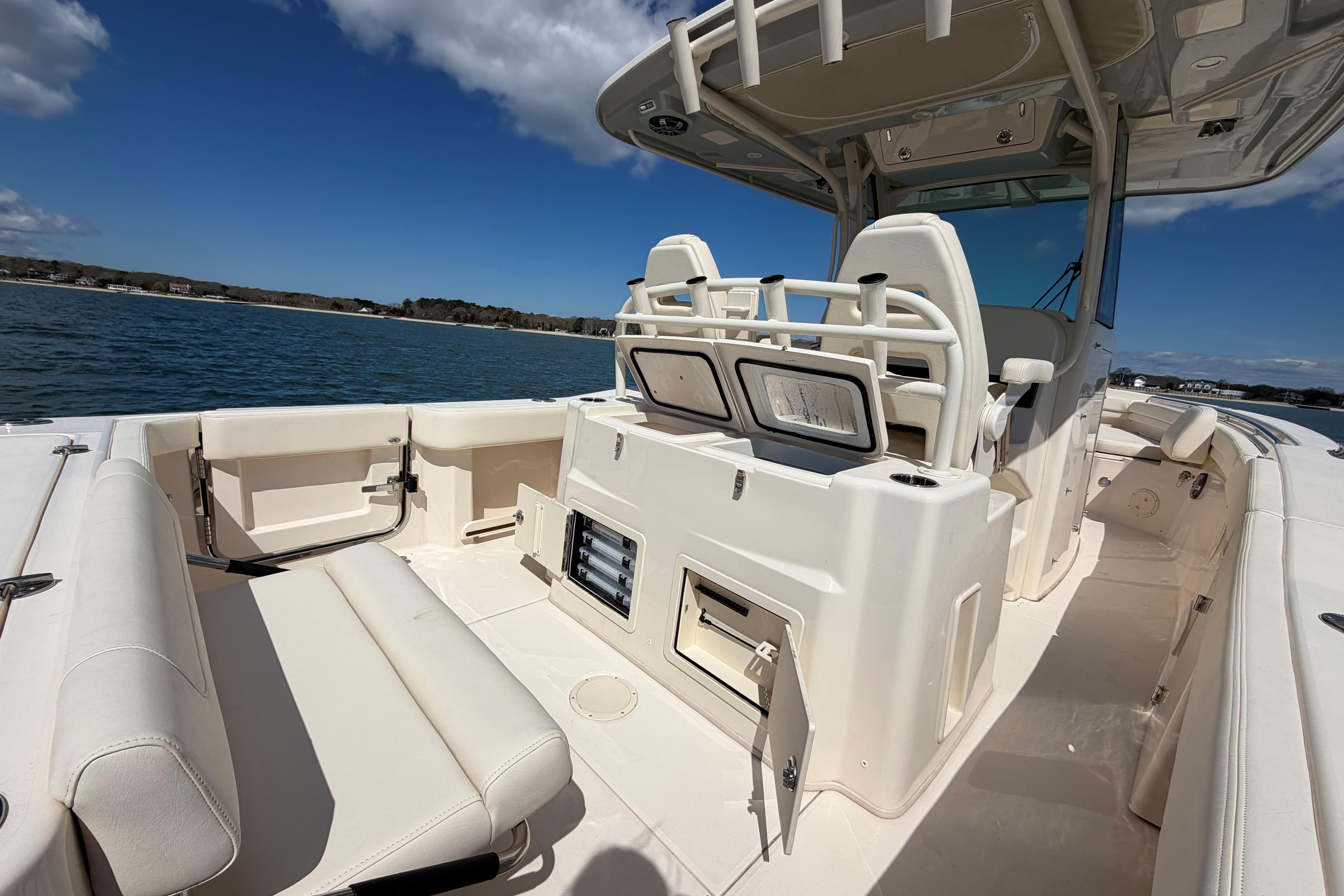 2026 Grady-White Canyon 306 boat interior with seating and storage, on calm water.