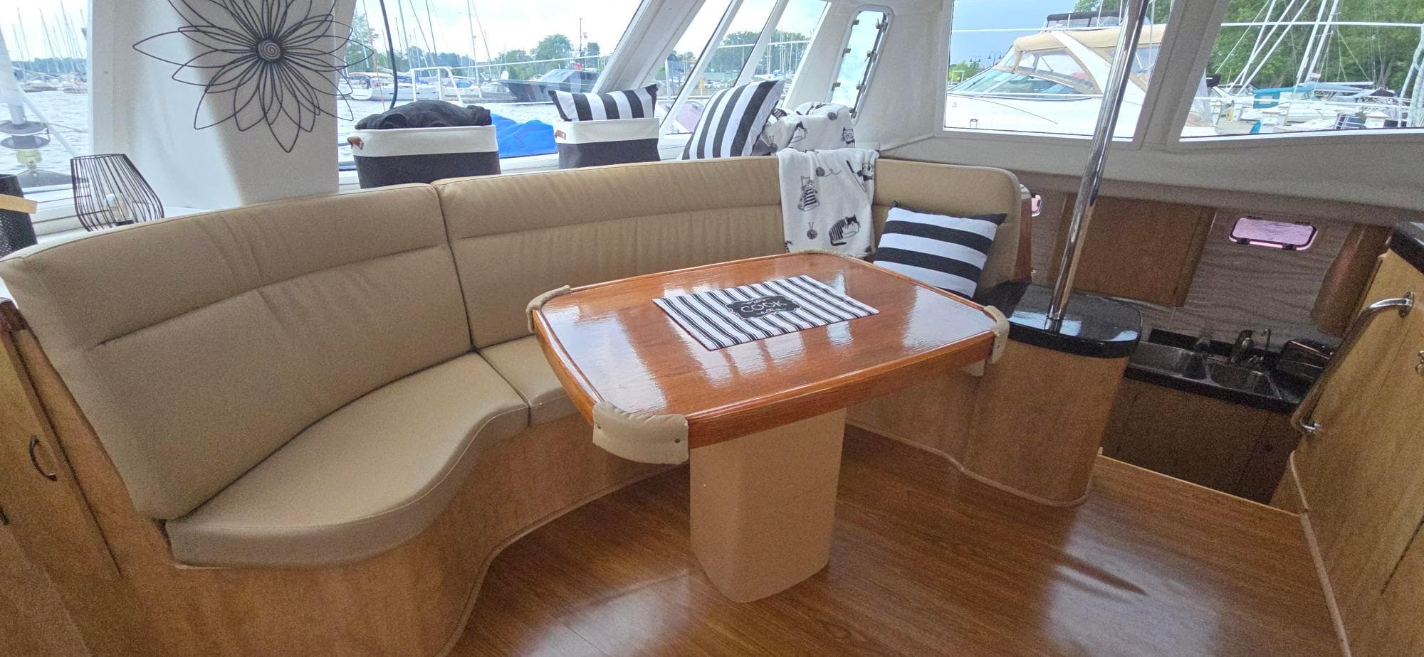 Interior of 2013 Kelsall Suncat 40 yacht with elegant seating and wooden table.