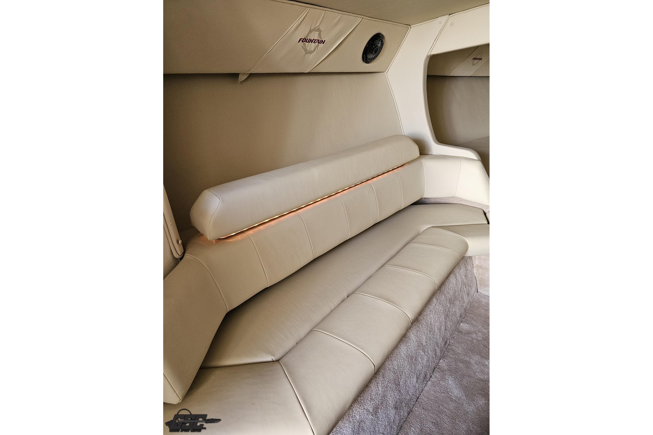 Luxurious interior of 2009 Fountain 47 Lightning boat with beige leather seating.