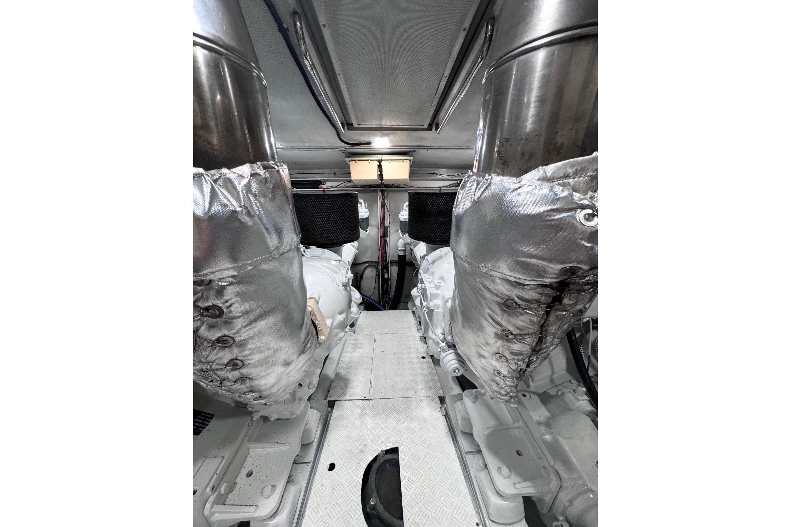 Engine room of 2003 Azimut Fly 68 yacht, featuring insulated components and metallic surfaces.