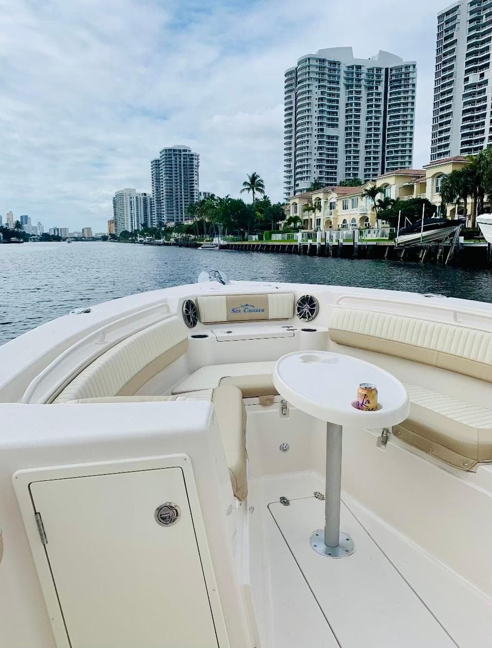 2019 Sea Chaser 27 HFC boat on waterway, city skyline in background.