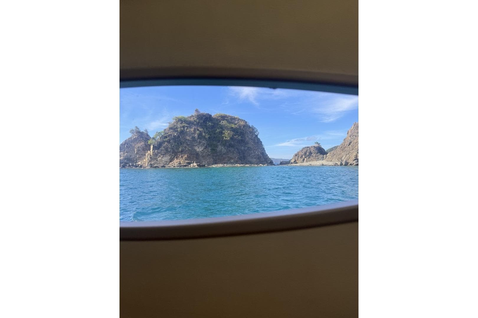 View of rocky coastline through Fountaine Pajot Sanya 57 window, 2013 model.