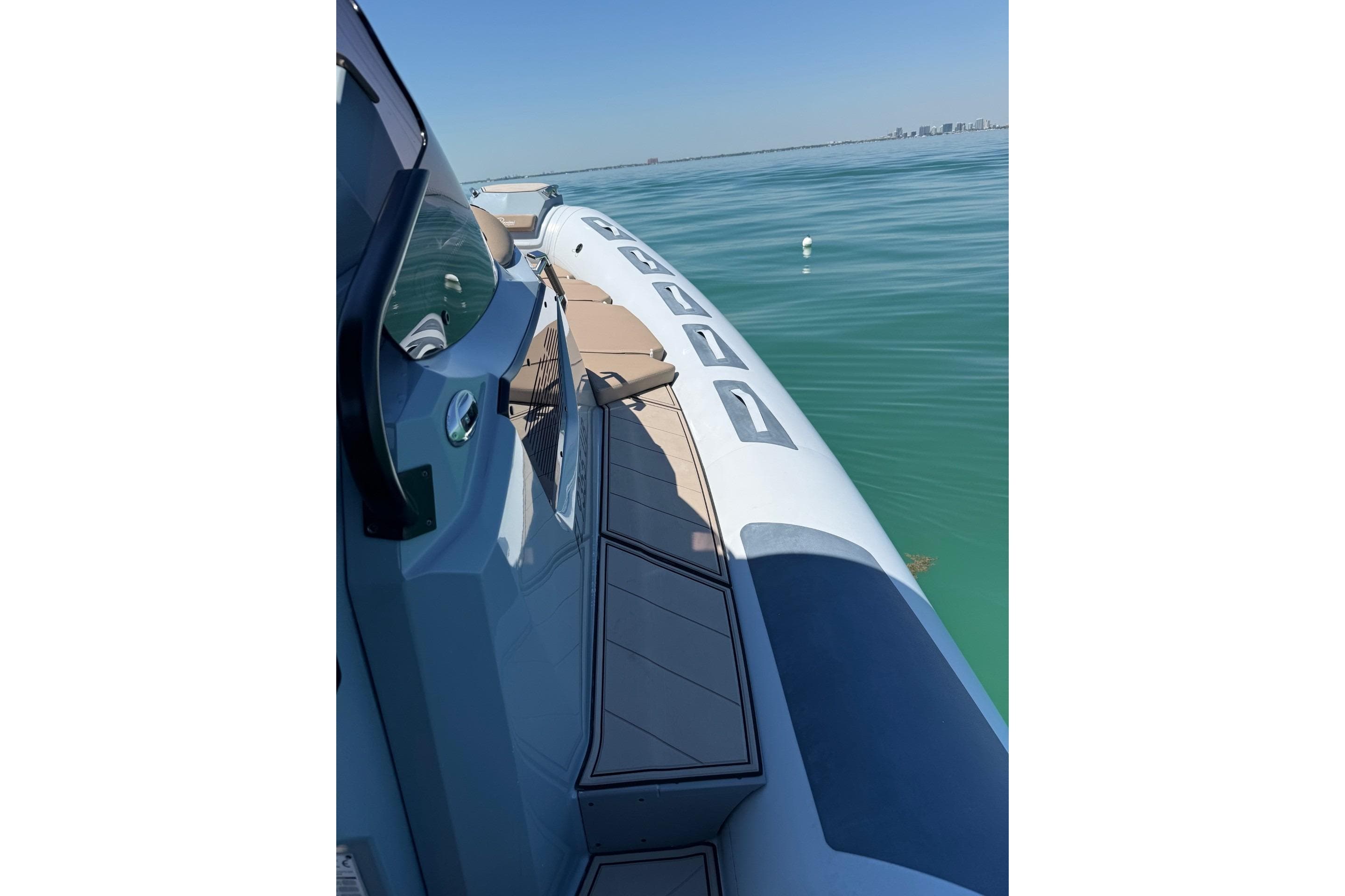 2026 Ranieri Cayman Executive boat on calm blue water, showcasing sleek design.