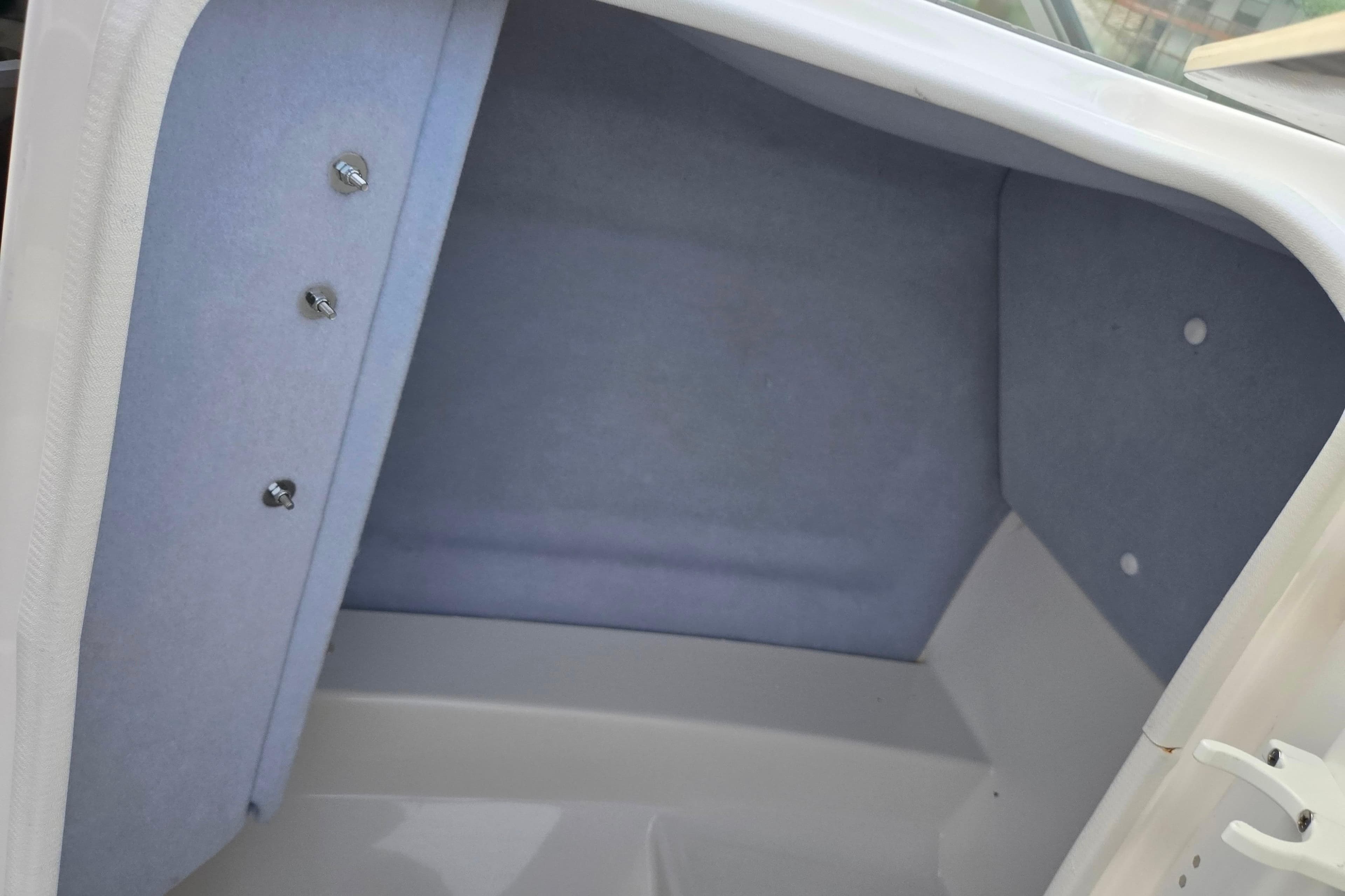 Interior storage compartment of 2021 Yamaha Boats AR250, featuring a clean, carpeted finish.