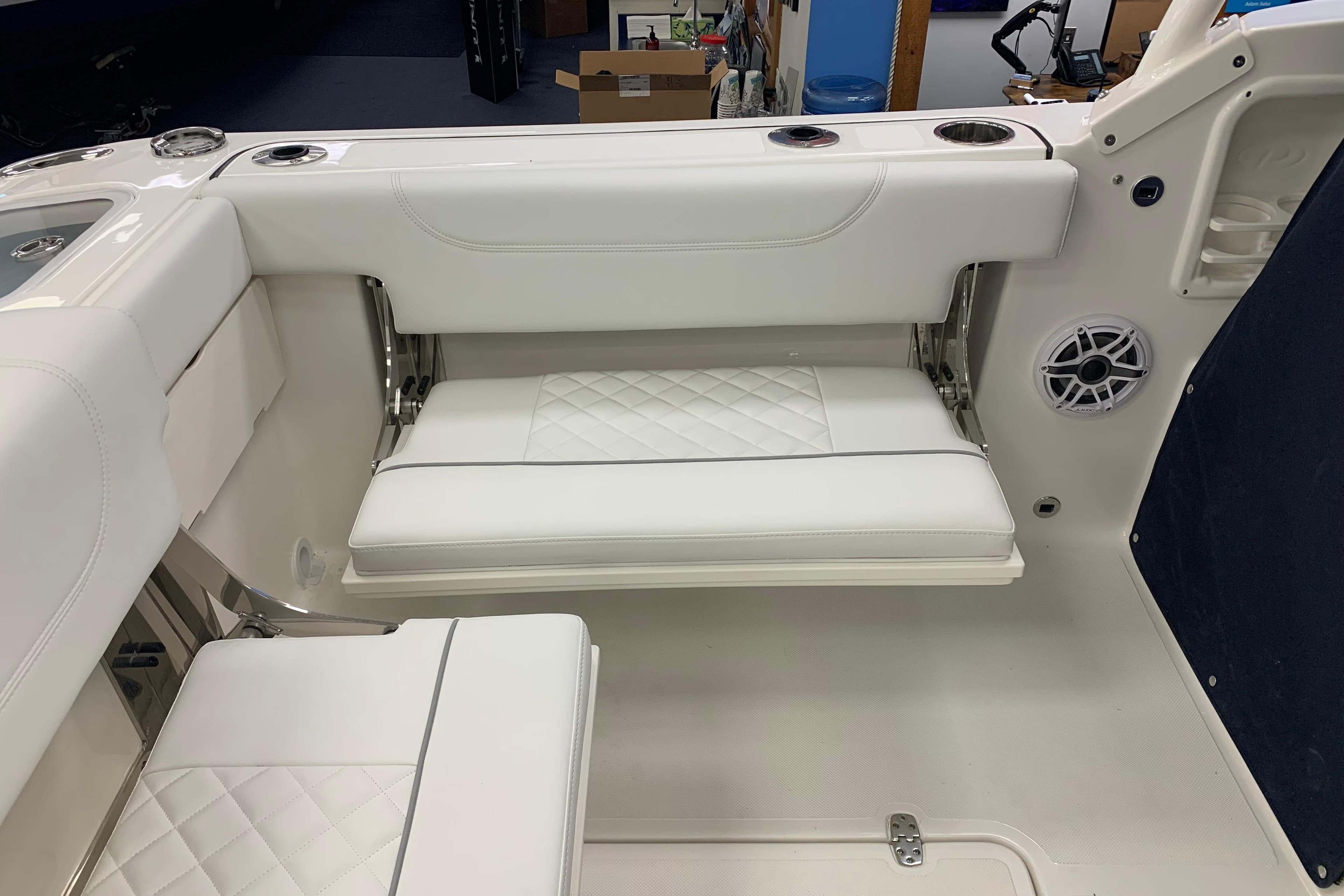 2025 Pursuit DC 266 Dual Console boat interior with white cushioned seating and cup holders.