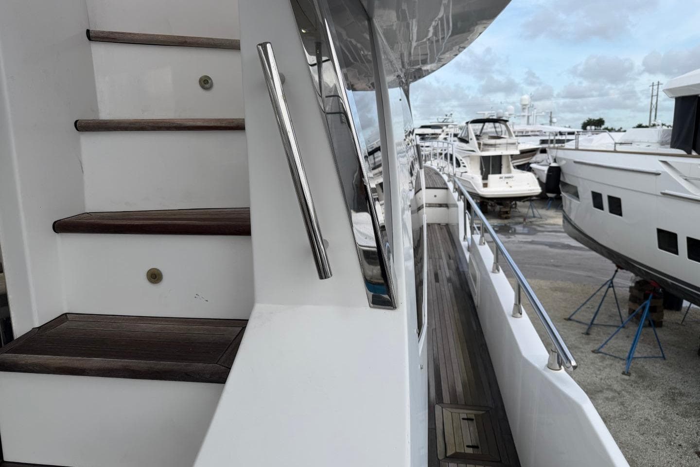 Staircase and deck view of 2017 Azimut Fly 72 yacht in marina.