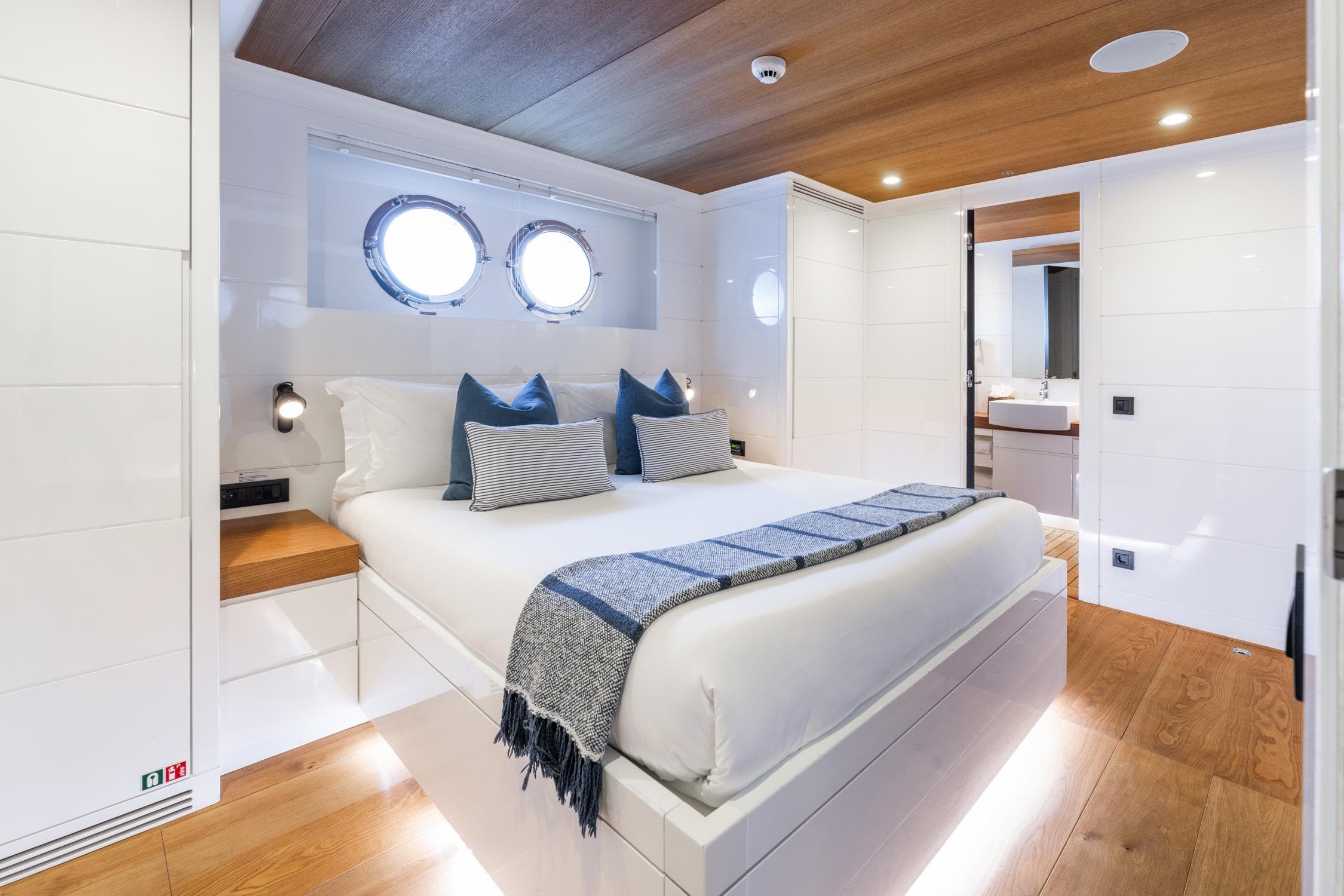 Luxurious Tansu Custom yacht bedroom, 2011 model, featuring modern design and elegant wood accents.