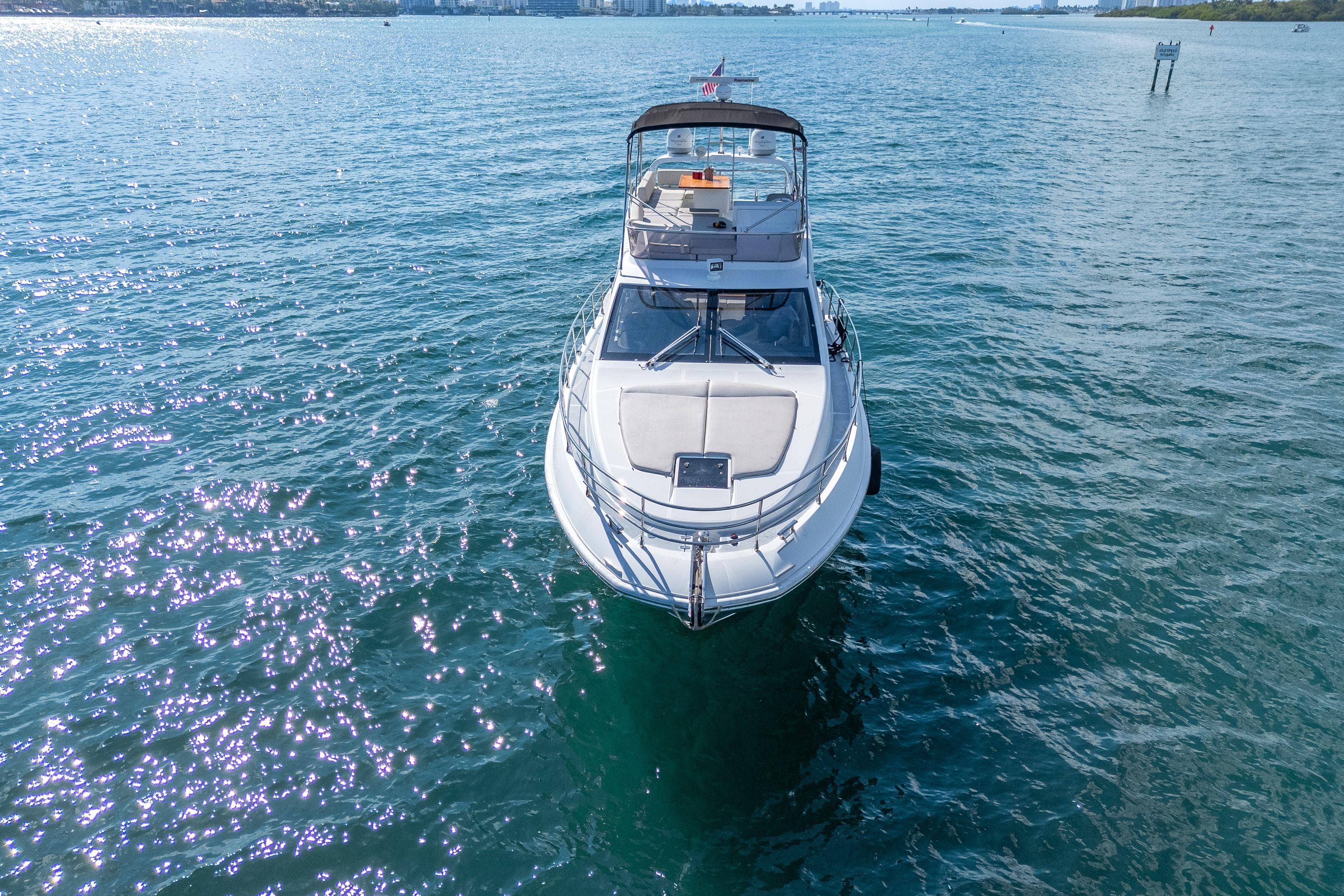 2013 Azimut 45 Flybridge yacht on serene blue waters, aerial view.