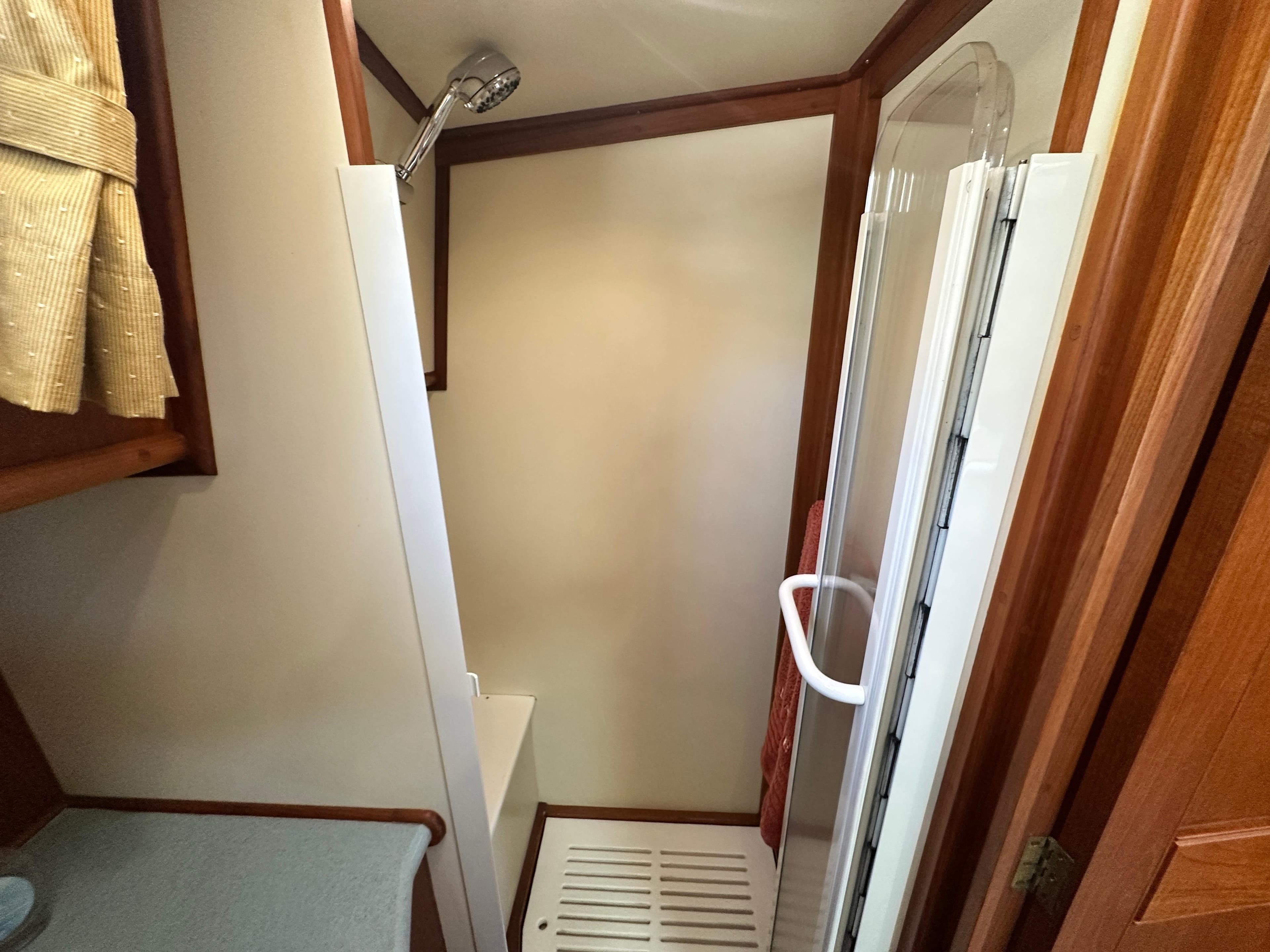 Shower area in 2004 Grand Banks 49 Eastbay HX yacht, featuring wood accents and modern fixtures.