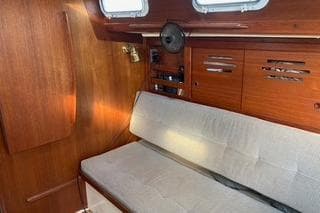 1985 Tartan 28 Piper sailboat interior with wooden paneling and cushioned seating.