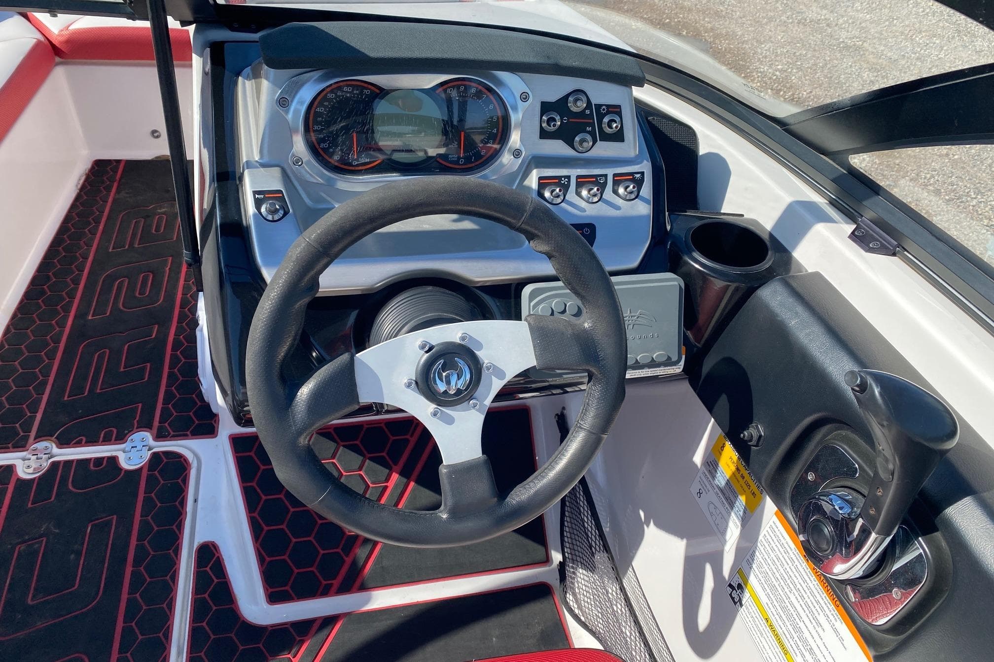 Cockpit view of a 2014 Scarab 195 H.O. Impulse boat with steering wheel and controls.