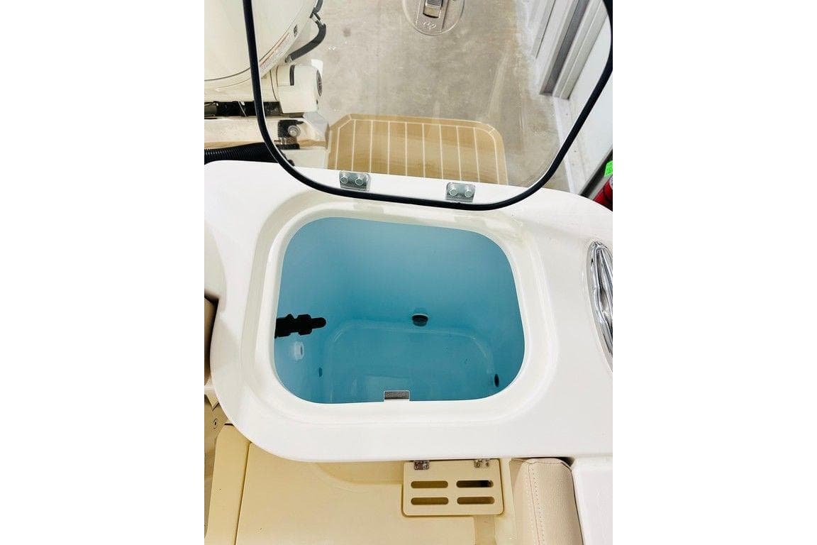 Livewell compartment on 2026 Scout 260 LXF boat, featuring a clear lid and blue interior.
