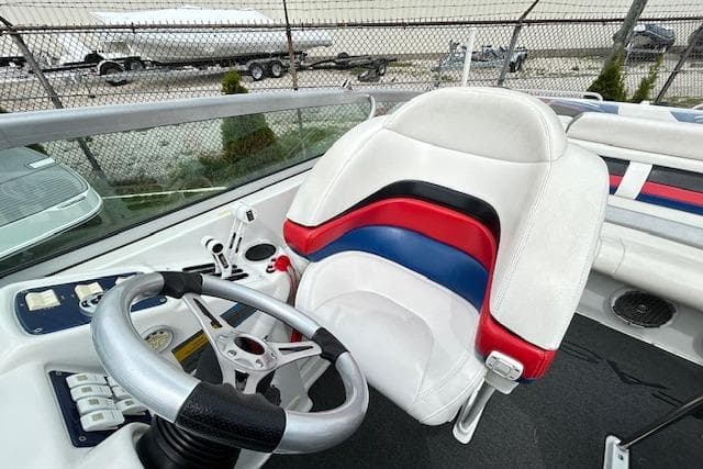 2004 Formula 292 FASTech boat cockpit with steering wheel and colorful seat design.