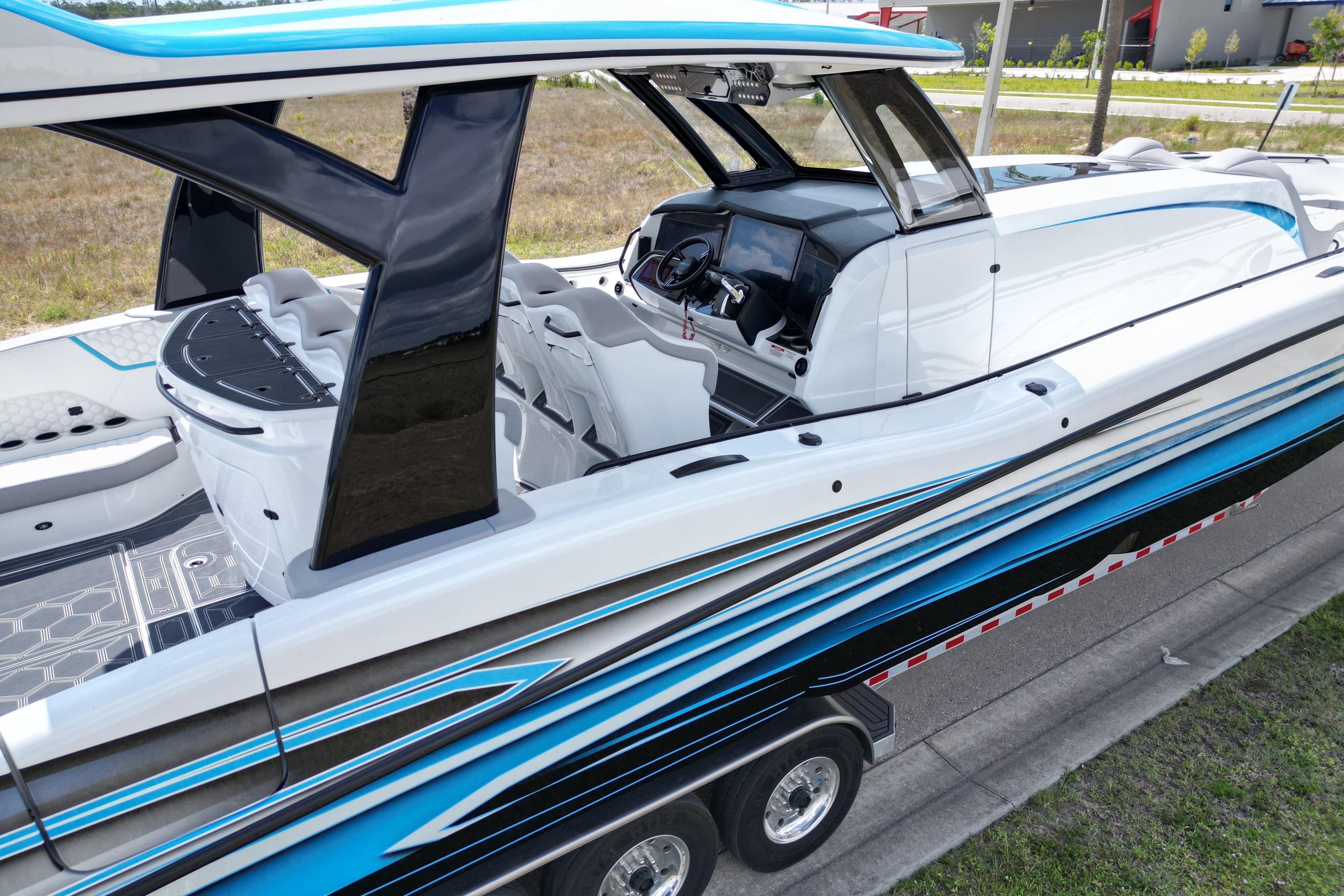 2024 MTI V50 boat with sleek design, modern interior, and vibrant blue accents.
