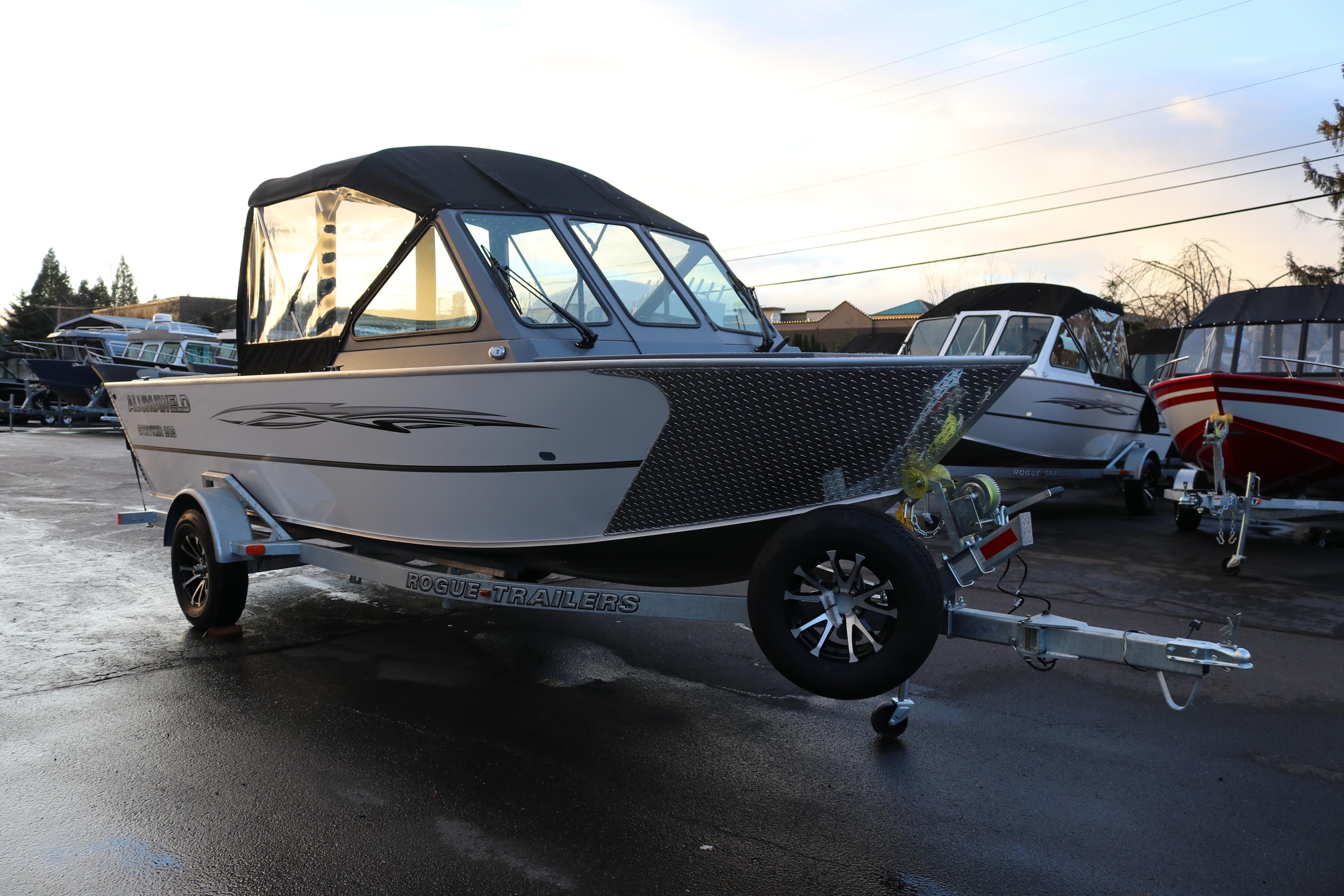 2026 Alumaweld Stryker 202 boat on trailer in outdoor showroom.