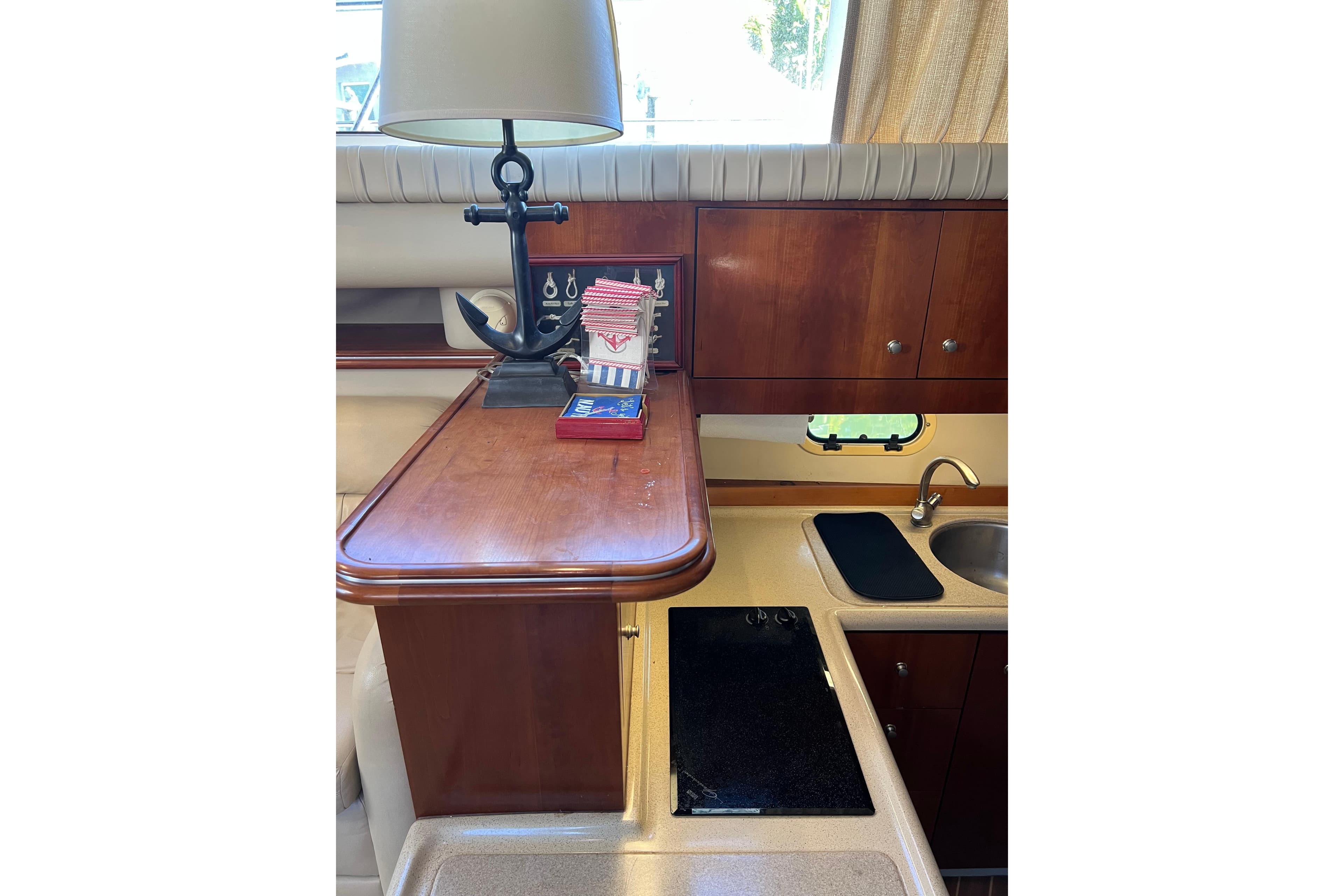 2004 Cruisers Yachts 3750 Motoryacht interior with wooden cabinetry and compact kitchen area.