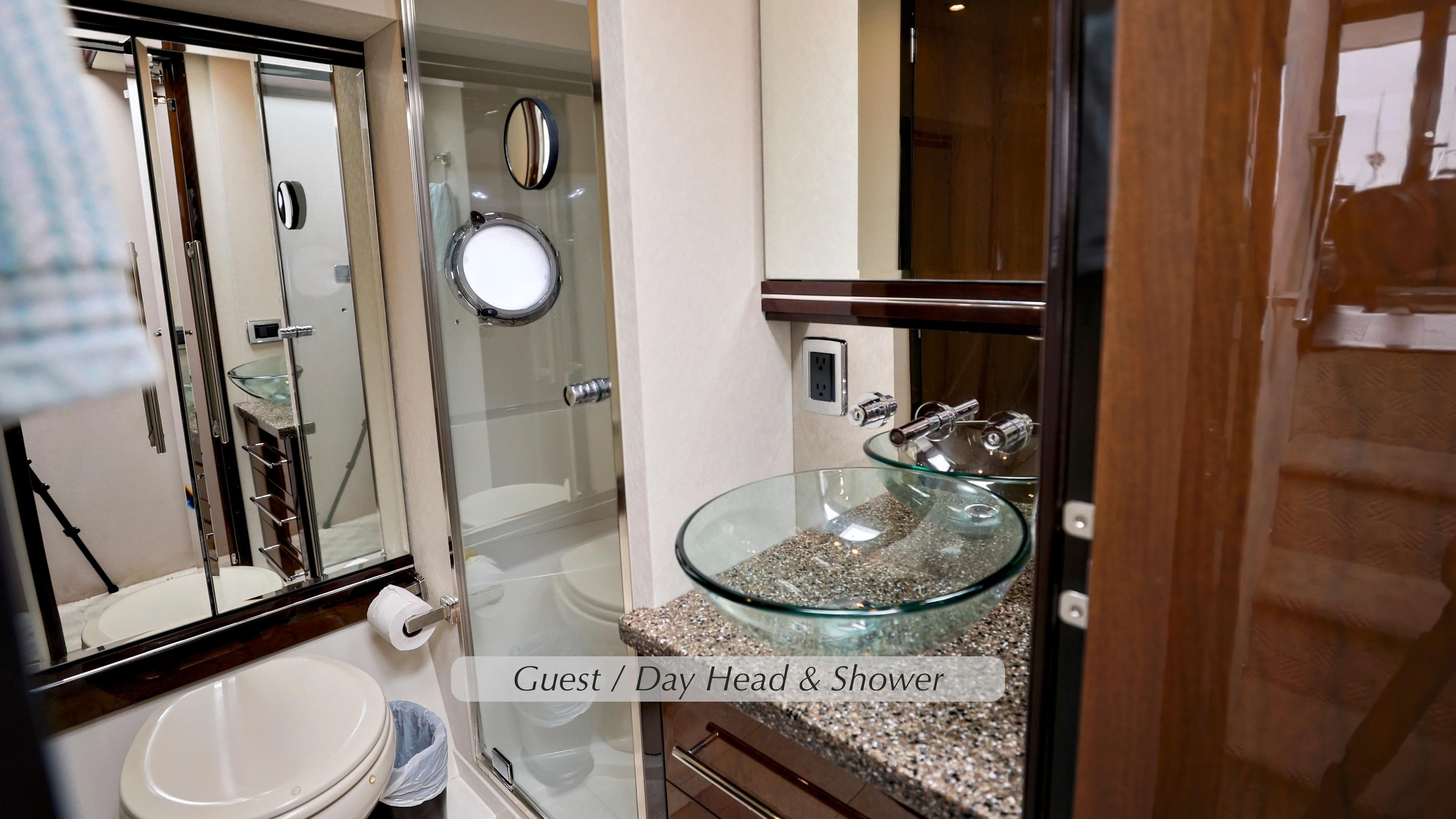 Luxurious bathroom in 2013 Marquis 500 Sport Bridge yacht with glass sink and shower.
