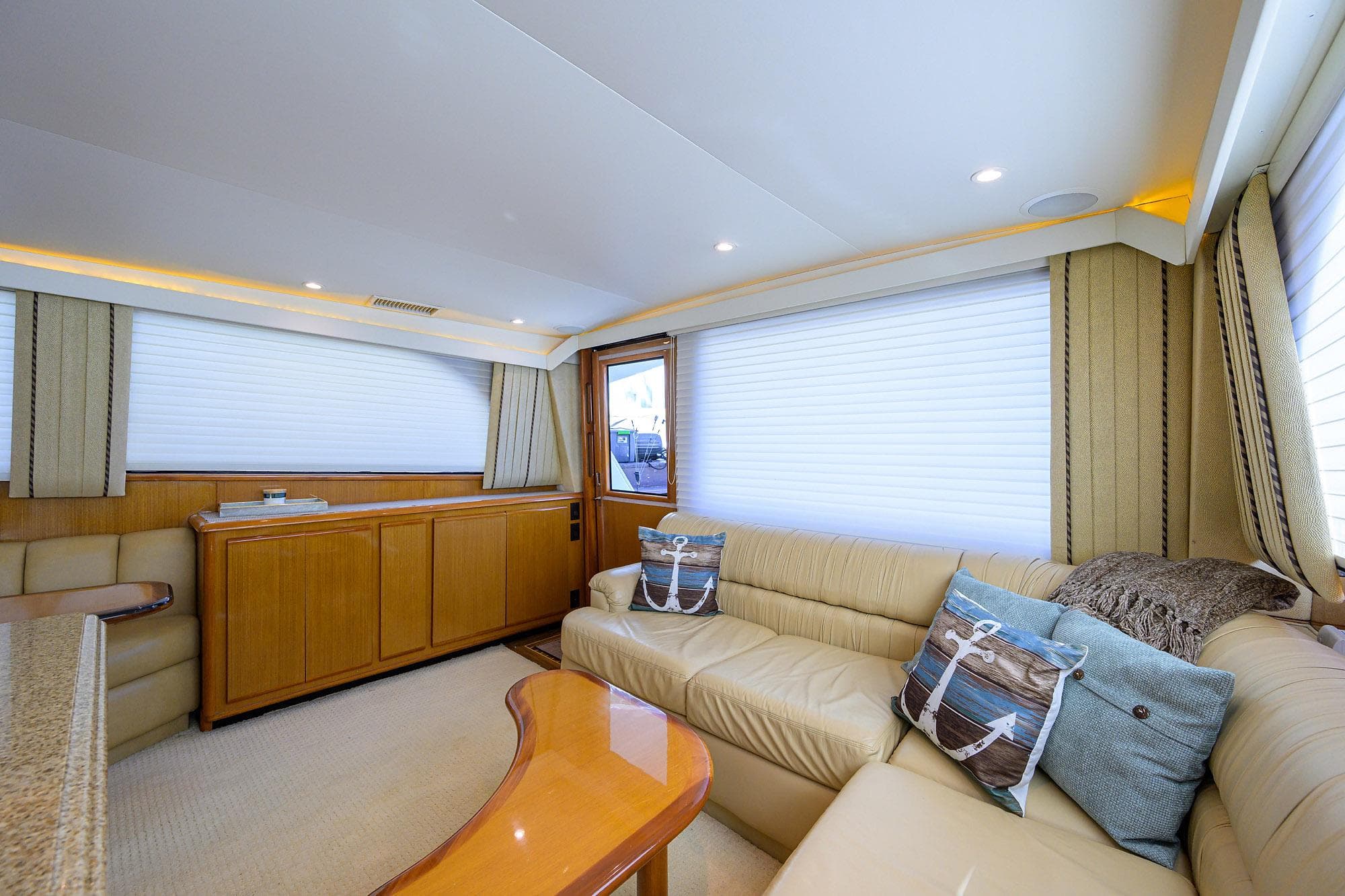 Luxurious interior of a 2000 Viking 50 Convertible yacht with plush seating and elegant decor.