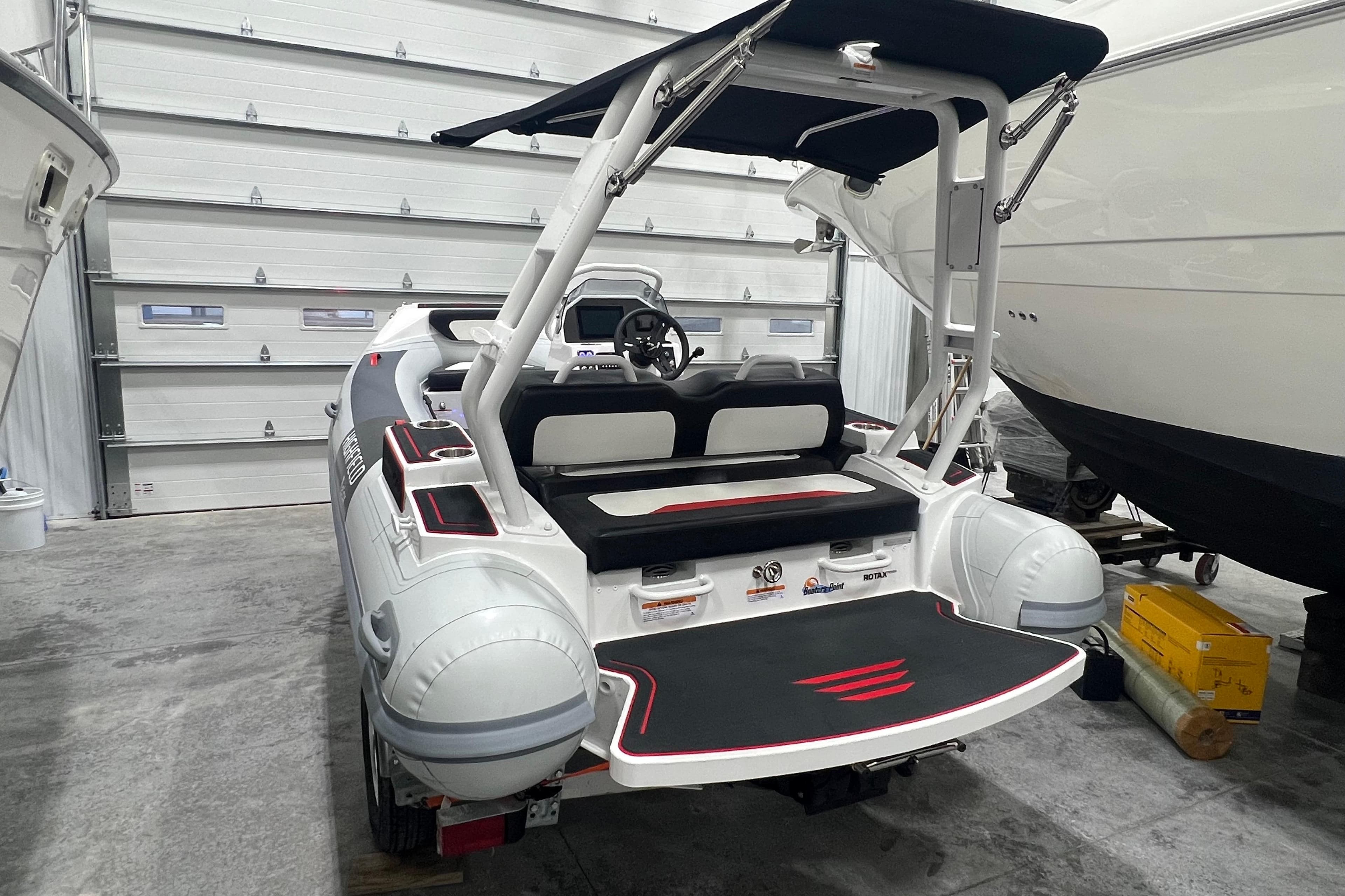 2025 Highfield Velox 420 boat in a garage, showcasing sleek design and modern features.