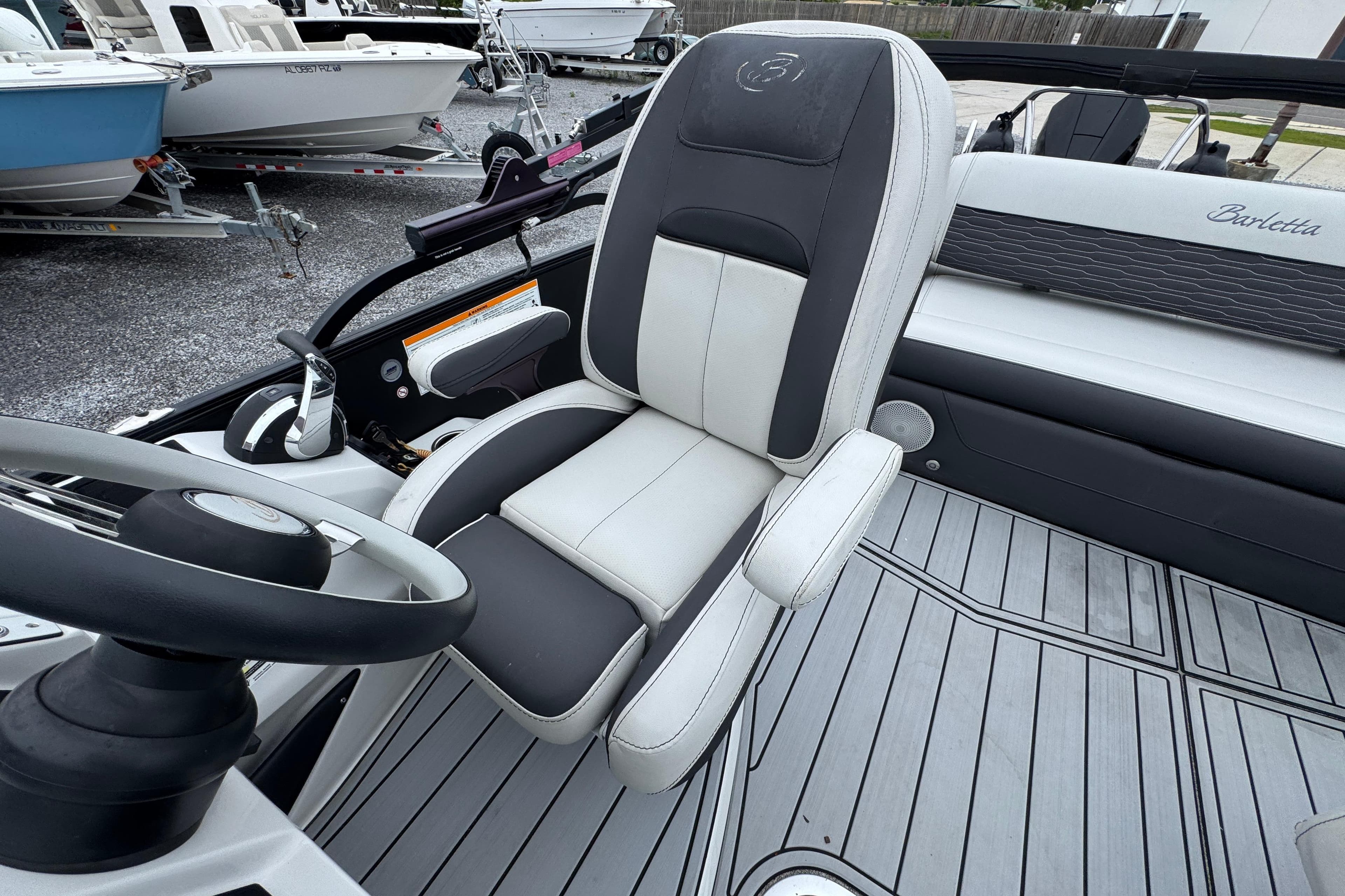 Captain's seat of 2023 Barletta CORSA 25UC boat, featuring sleek design and modern controls.