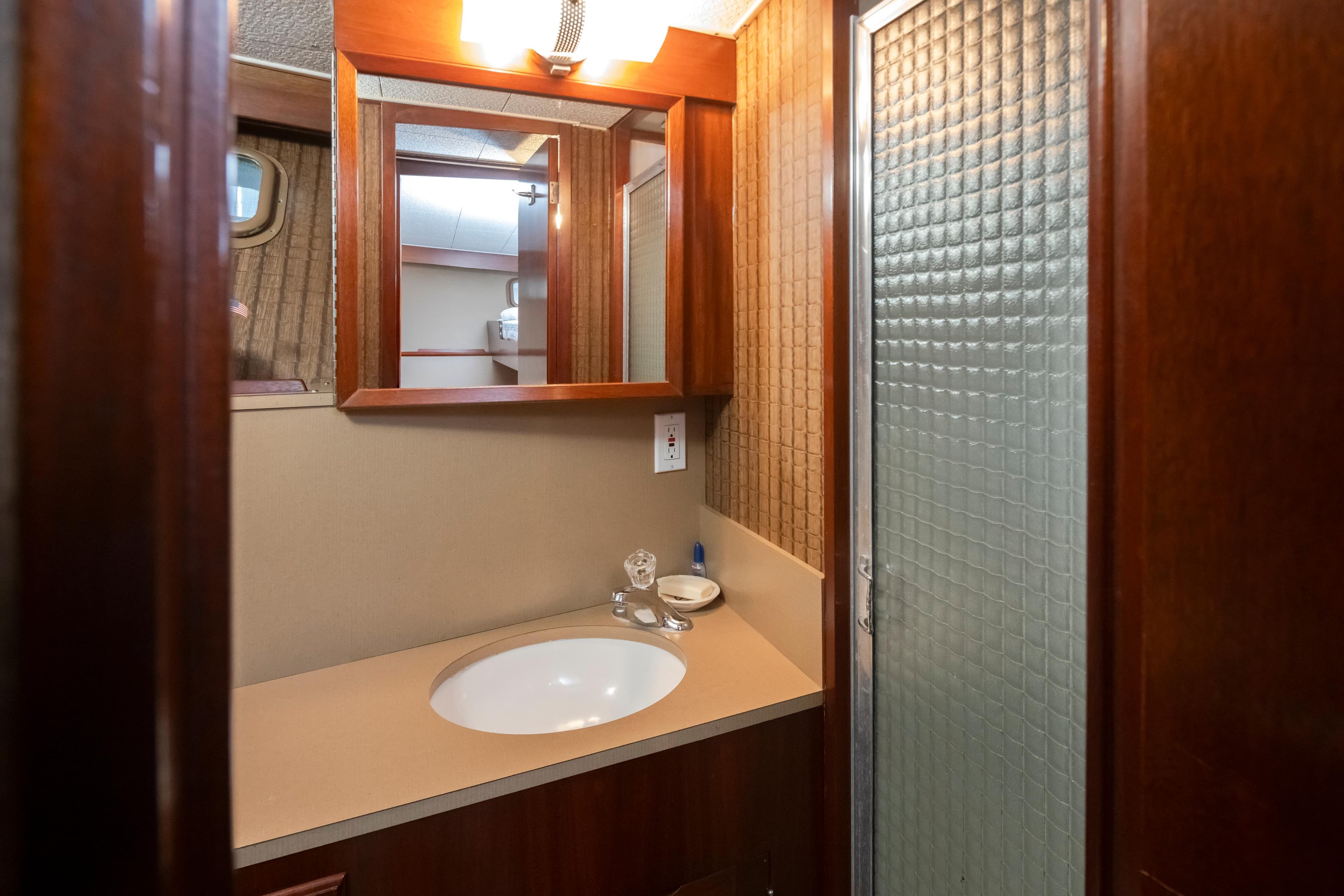 Bathroom in 1965 Stephens Flushdeck boat with mirror and shower.