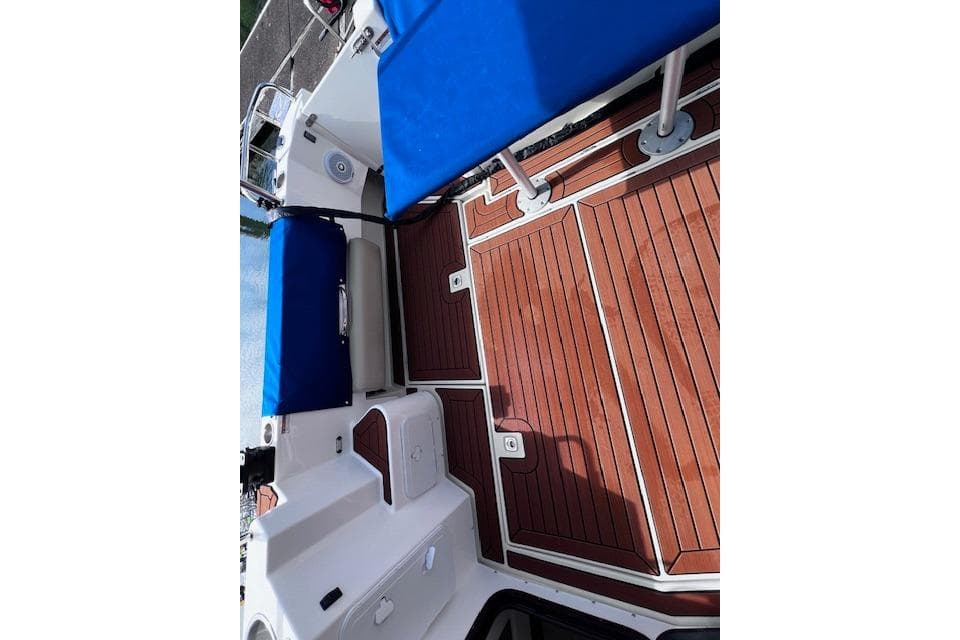 2021 Ranger Tugs R-31 CB boat deck with blue seating and wooden flooring.
