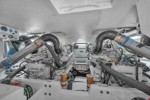 Engine room of a 1993 Viking Convertible boat, showcasing dual engines and mechanical components.