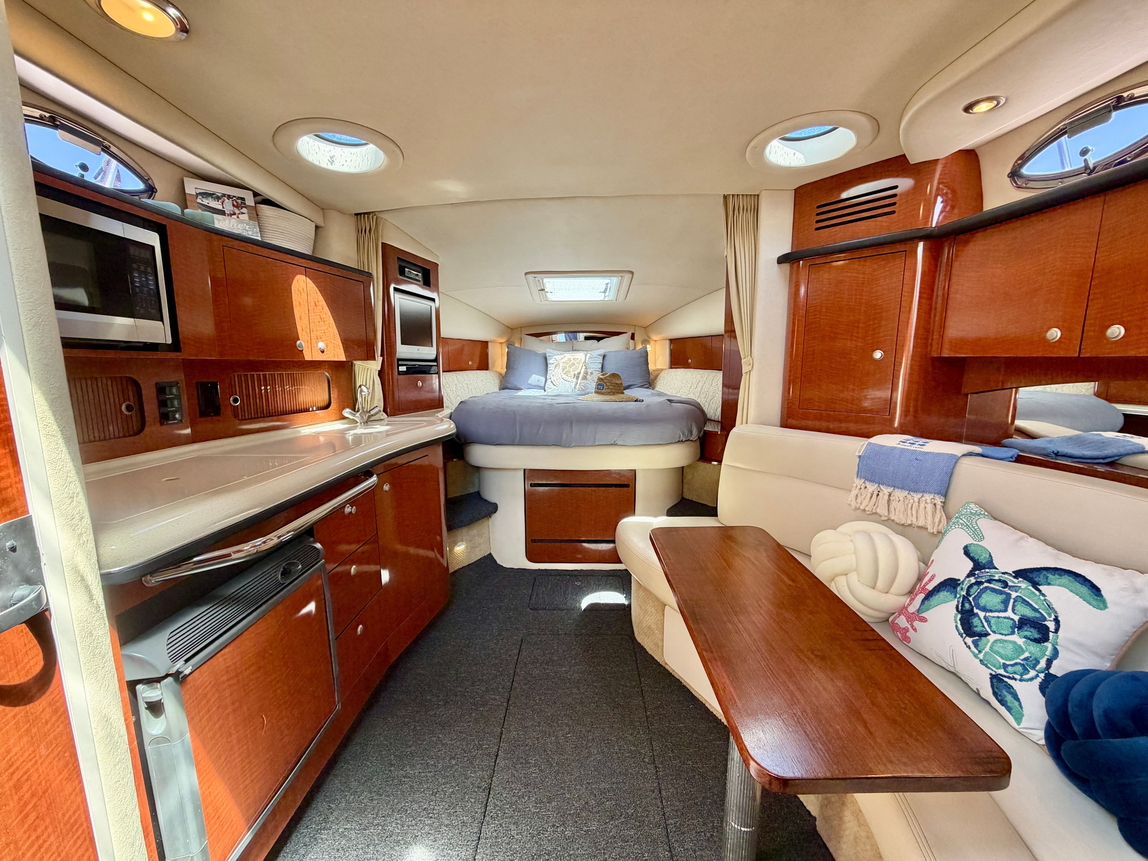 Interior of a 2005 Sea Ray Sundancer 320 yacht with kitchen and sleeping area.