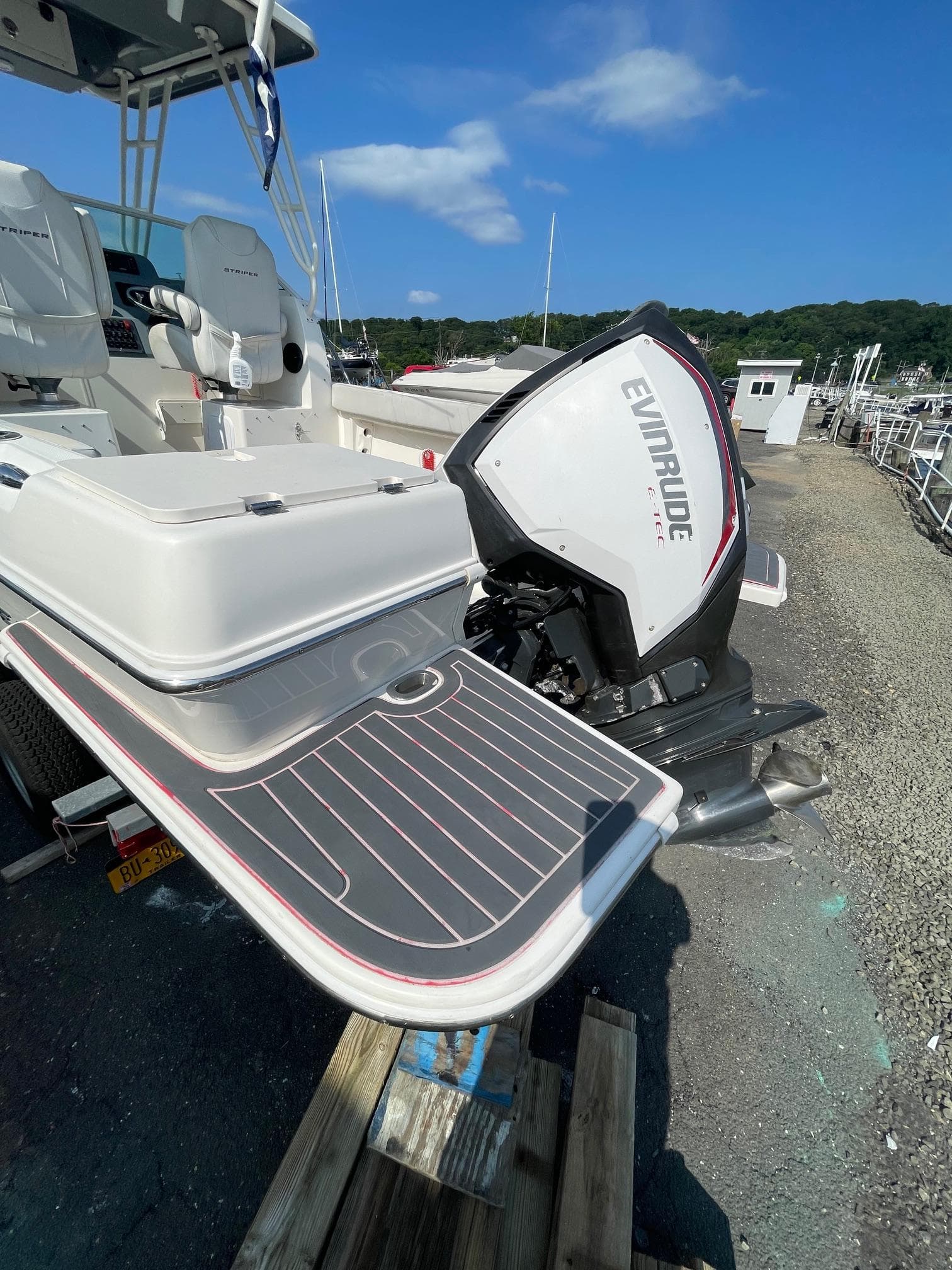 2018 Striper 200 Walkaround boat with Evinrude engine, docked on a sunny day.